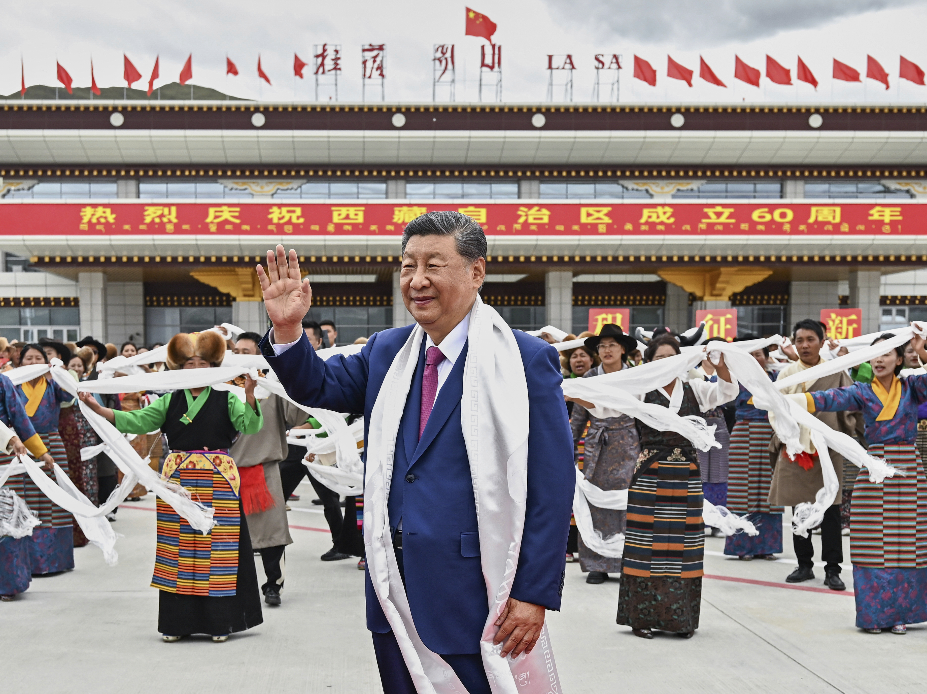 In this photo released by Xinhua News Agency, Chinese President Xi Jinping waves as he arrives at Lhasa in western China's Tibet Autonomous Region on Wednesday, Aug. 20, 2025, to attend an event to mark the 60th anniversary of the consolidation of Beijing's long-contested rule over the Himalayan territory. (Yan Yan/Xinhua via AP)