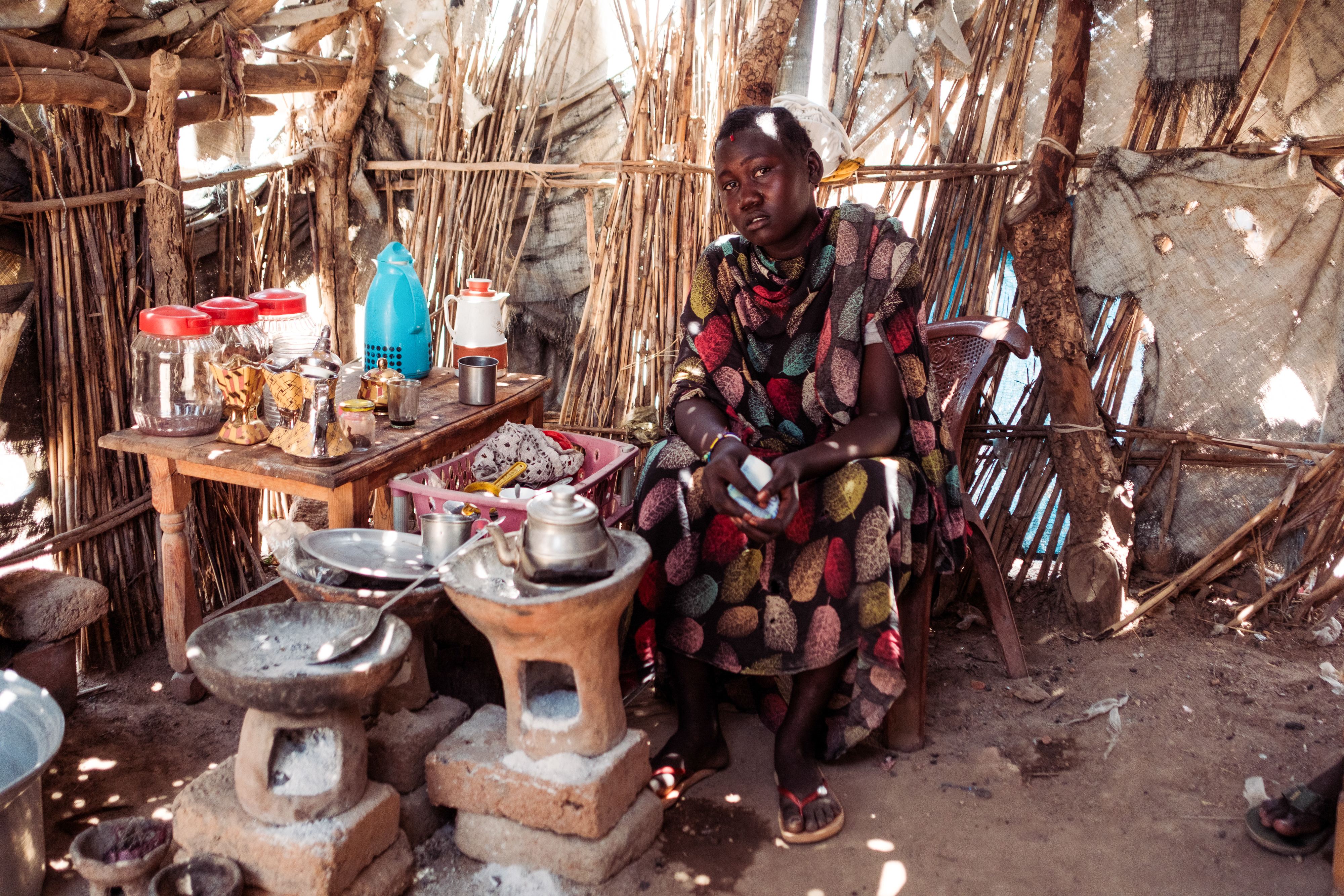 Ibtisam Hilmi, 14, an IDP displaced by fighting between the Rapid Support Forces and the Sudan Armed Forces sits serving coffee in a cafe she now works in serving many RSF fighters In Tongoli on April 22, 2025.