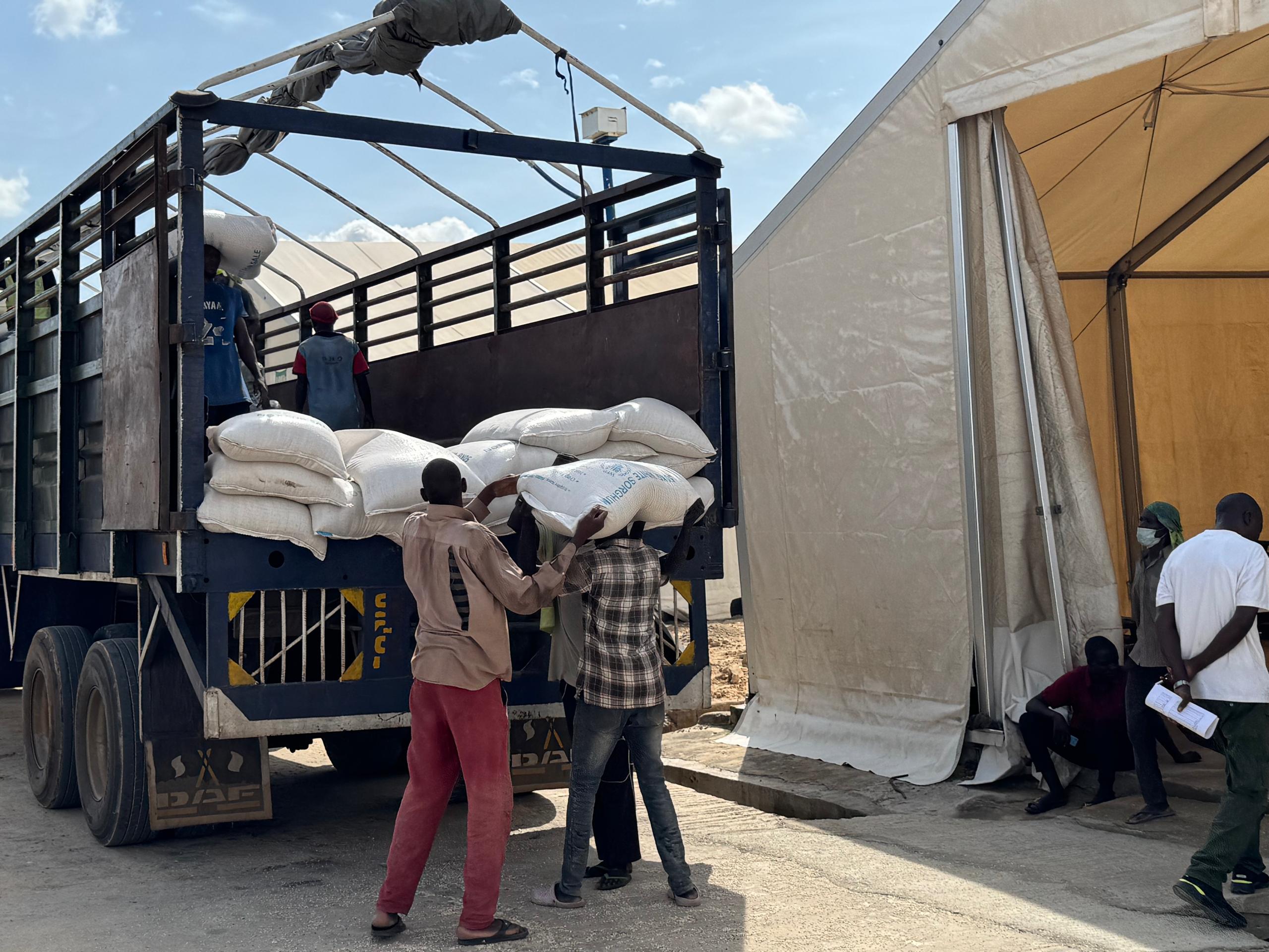 Men load WFP food truck in Maiduguri, Nigeria
