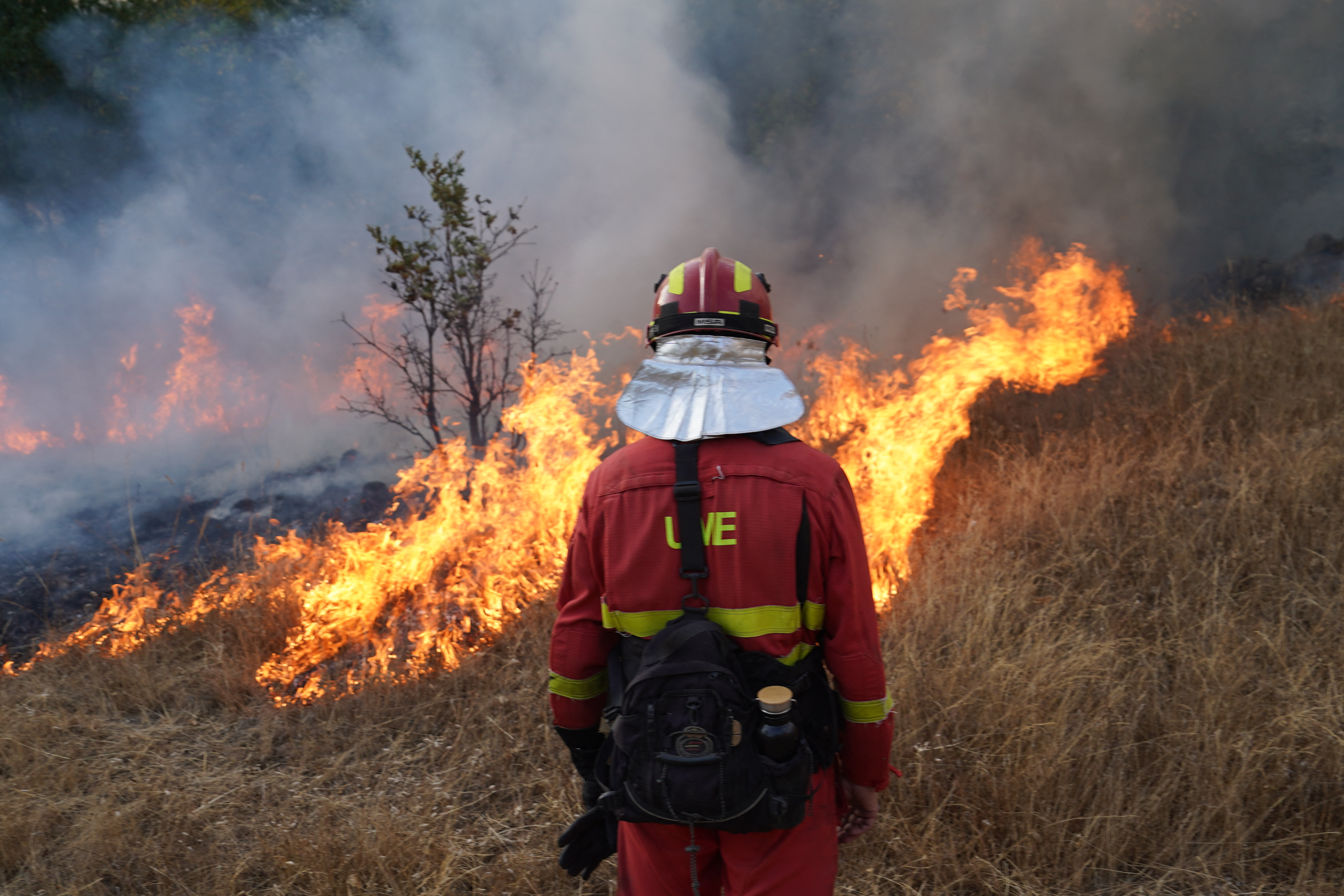 A member of Spain's Military Emergency Unit (UME) tackles a wildfire in Garano, northwestern Spain, on August 25, 2025.