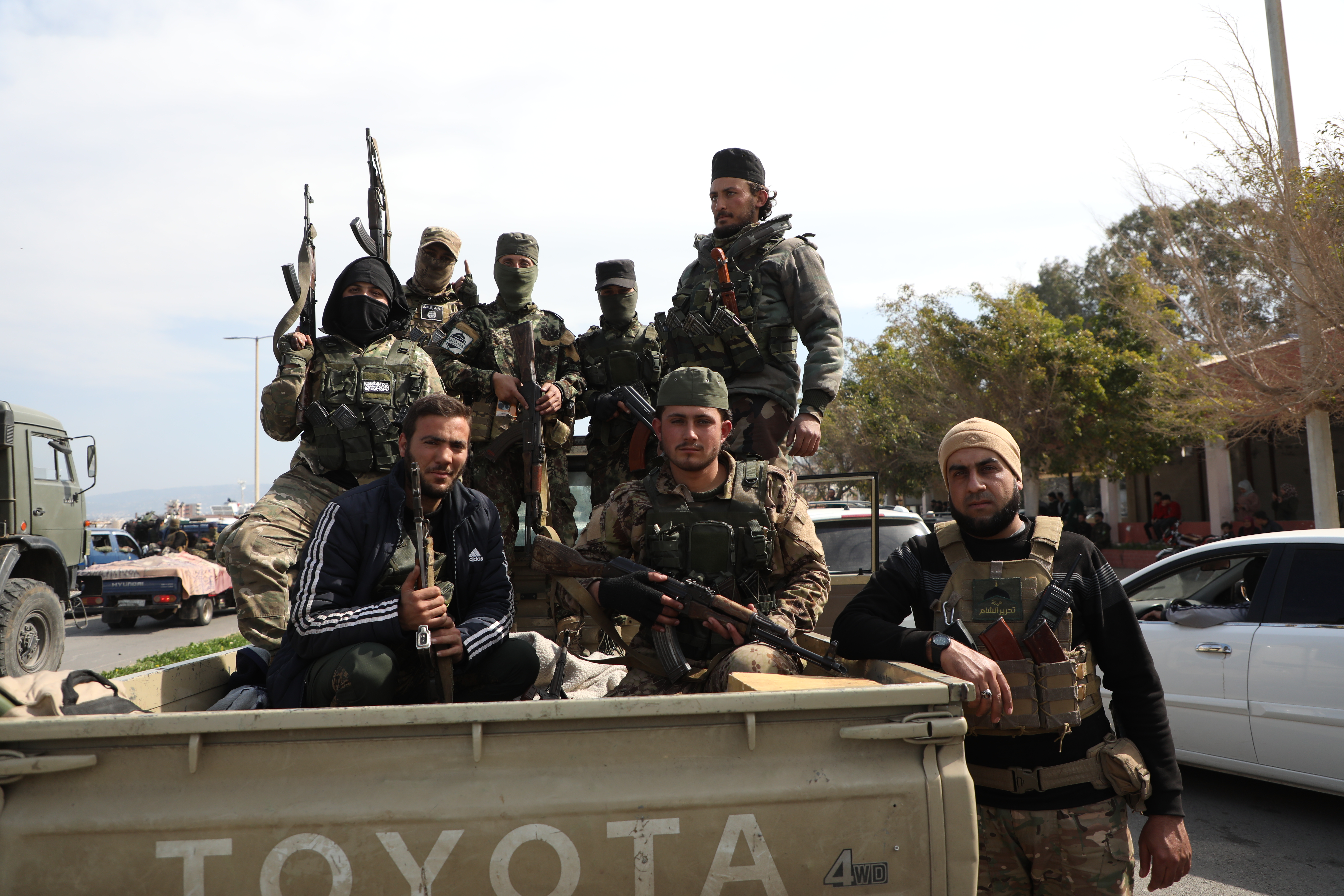 BANIYAS, SYRIA - MARCH 7: Fighters with the new Syrian government sit in a truck bed on March 7, 2025 in Baniyas, Syria. Dozens of people have been killed in clashes between loyalists of the deposed Assad regime and forces of the country's new rulers. It is the heaviest such fighting since Syrian rebels toppled the Assad regime last December. (Photo by Ali Haj Suleiman/Getty Images)