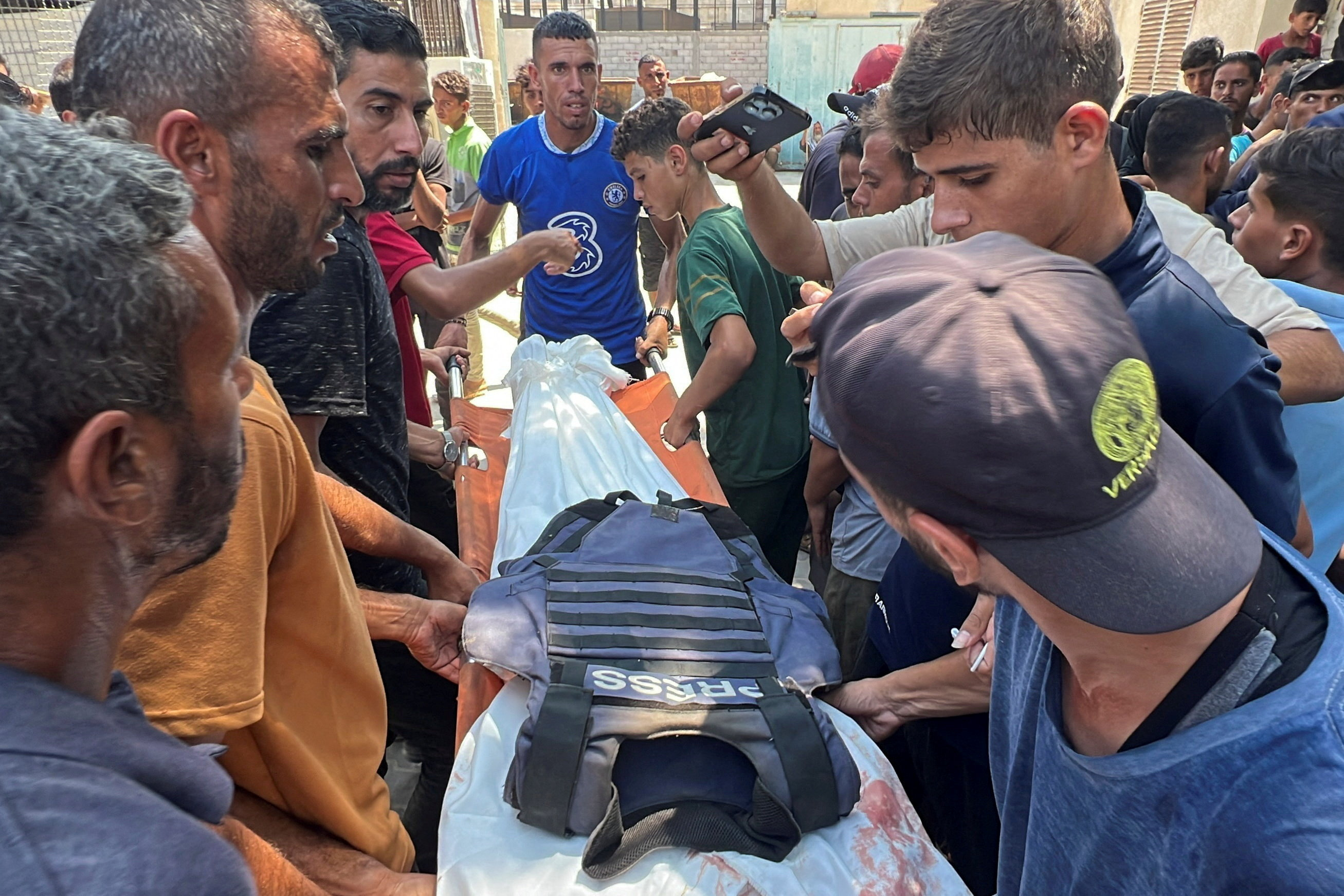Mourners carry the body of Palestinian cameraman Hussam al-Masri.