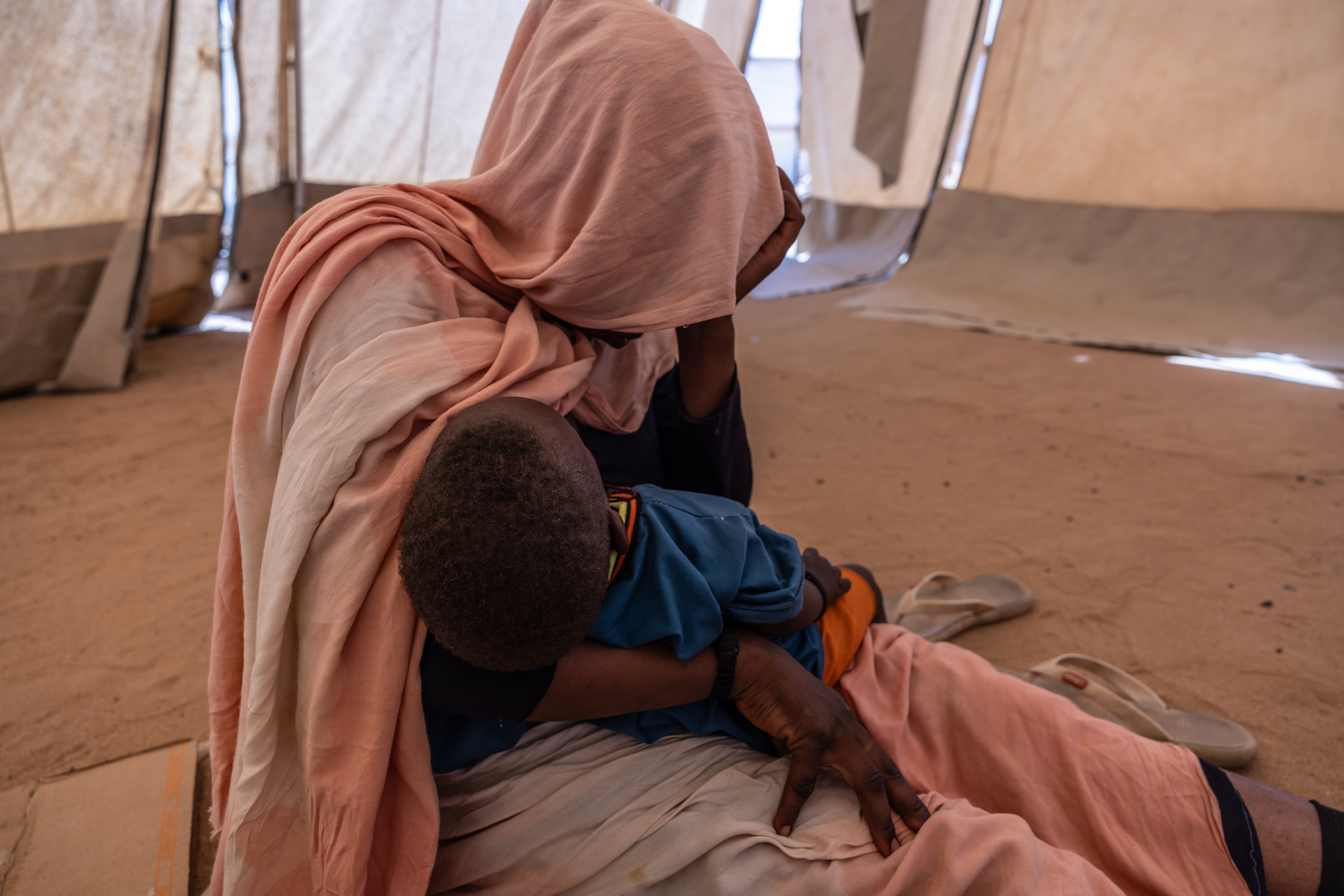 Rabia holds her child Awa, the child of a rape by a Chadian police officer. Adre Transit Camp, Eastern Chad Caitlin Kelly