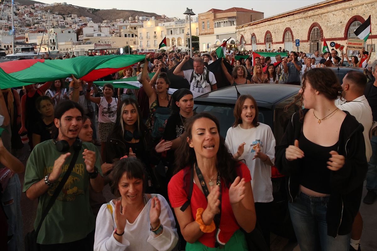 Supporters gather at the port in Syros, Greece, waving Palestinian flags as boats depart to join the Global Sumud Flotilla sailing toward Gaza in an effort to break the Israeli policy and show solidarity with the Palestinian people, on September 14, 2025. Photojournalist:Ayhan Mehmet