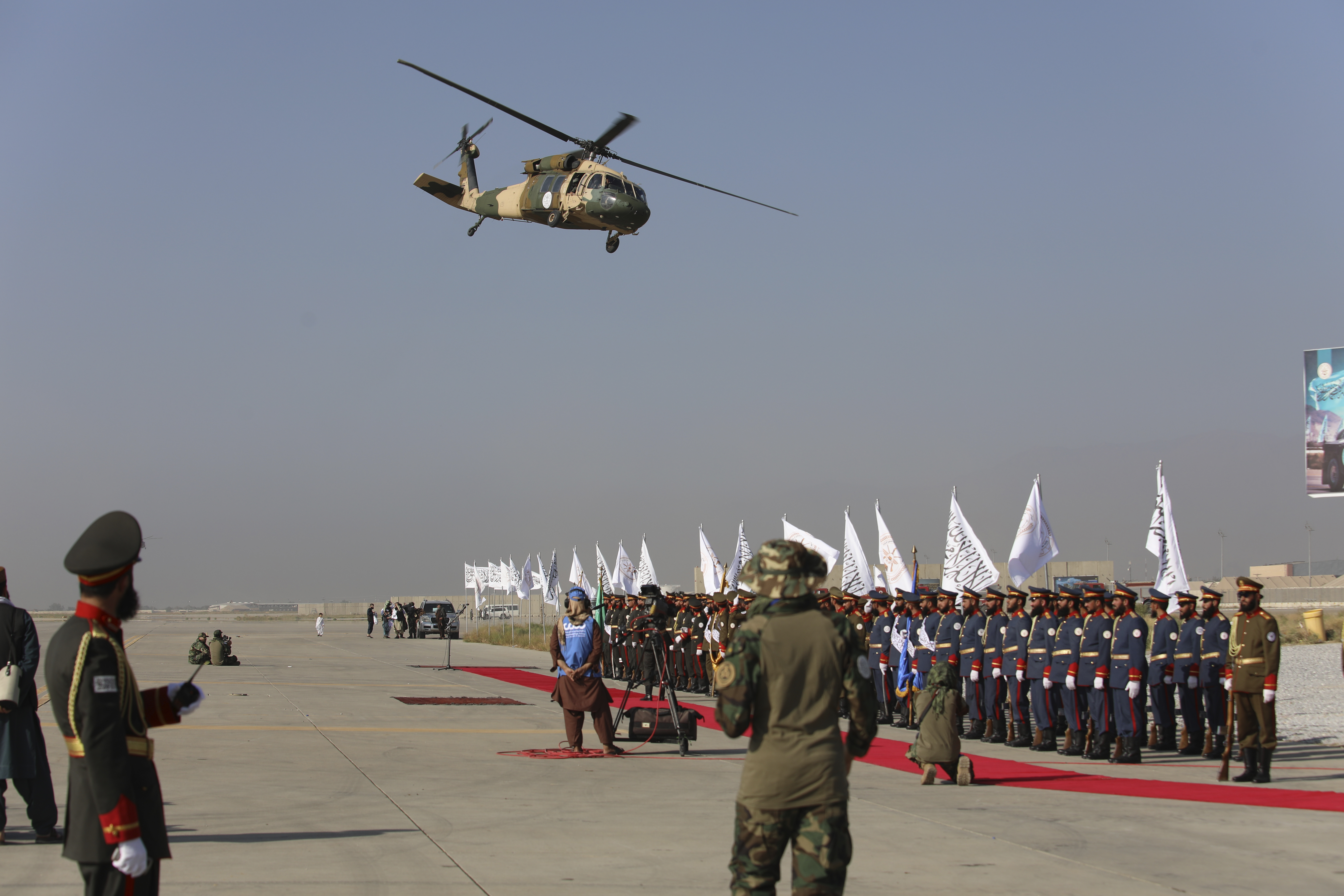 UH-60 Black Hawk helicopter fly during a military parade to mark the third anniversary of the withdrawal of U.S.-led troops from Afghanistan, in Bagram Air Base in the Parwan Province of Afghanistan, Wednesday, Aug. 14, 2024. (AP Photo/Siddiqullah Alizai)