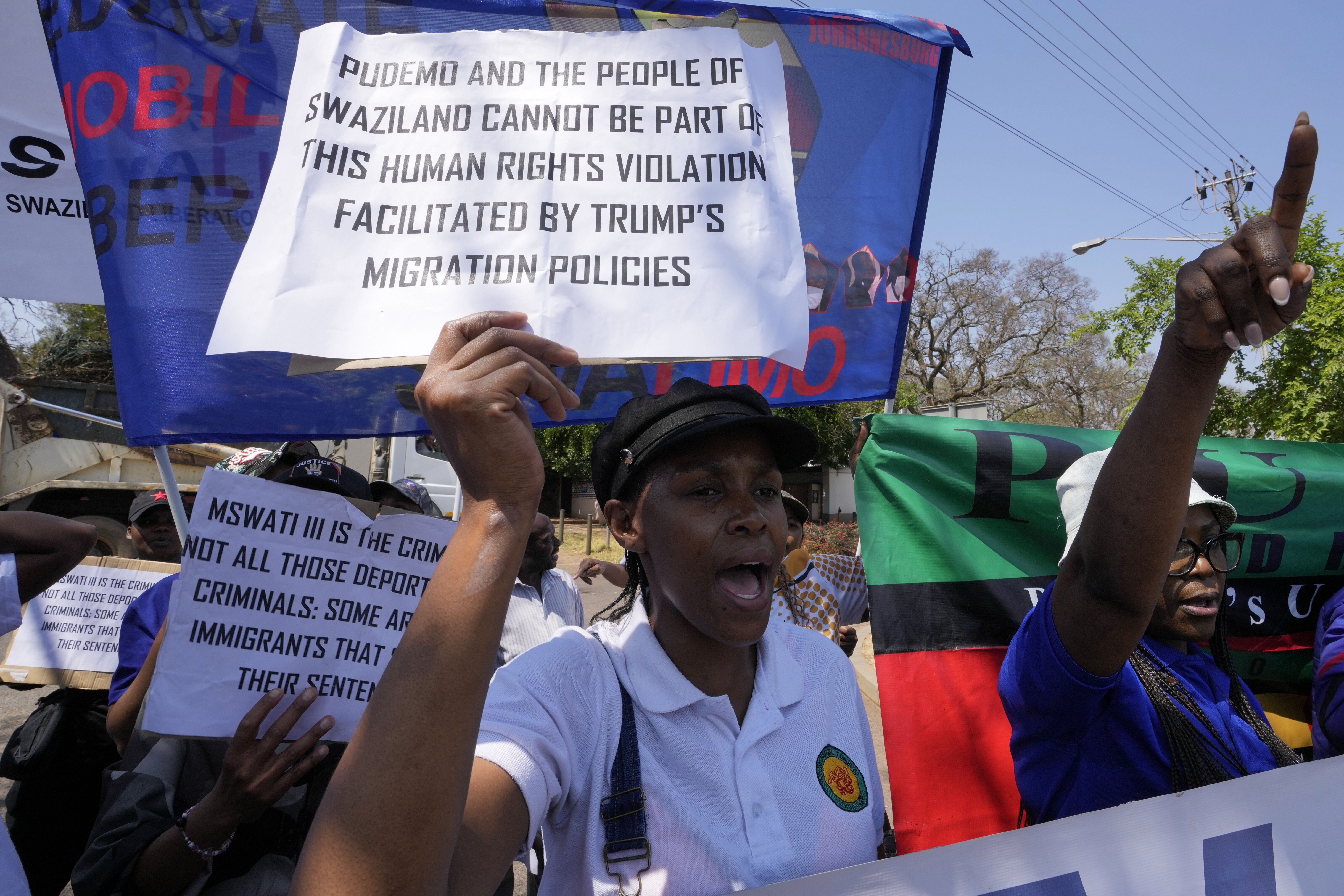 A pro-democracy activist holds up a sign at a protest that reads, "Pudemo and the people of Swaziland cannot be part of this human right violation facilitated by Trump's migration policies."