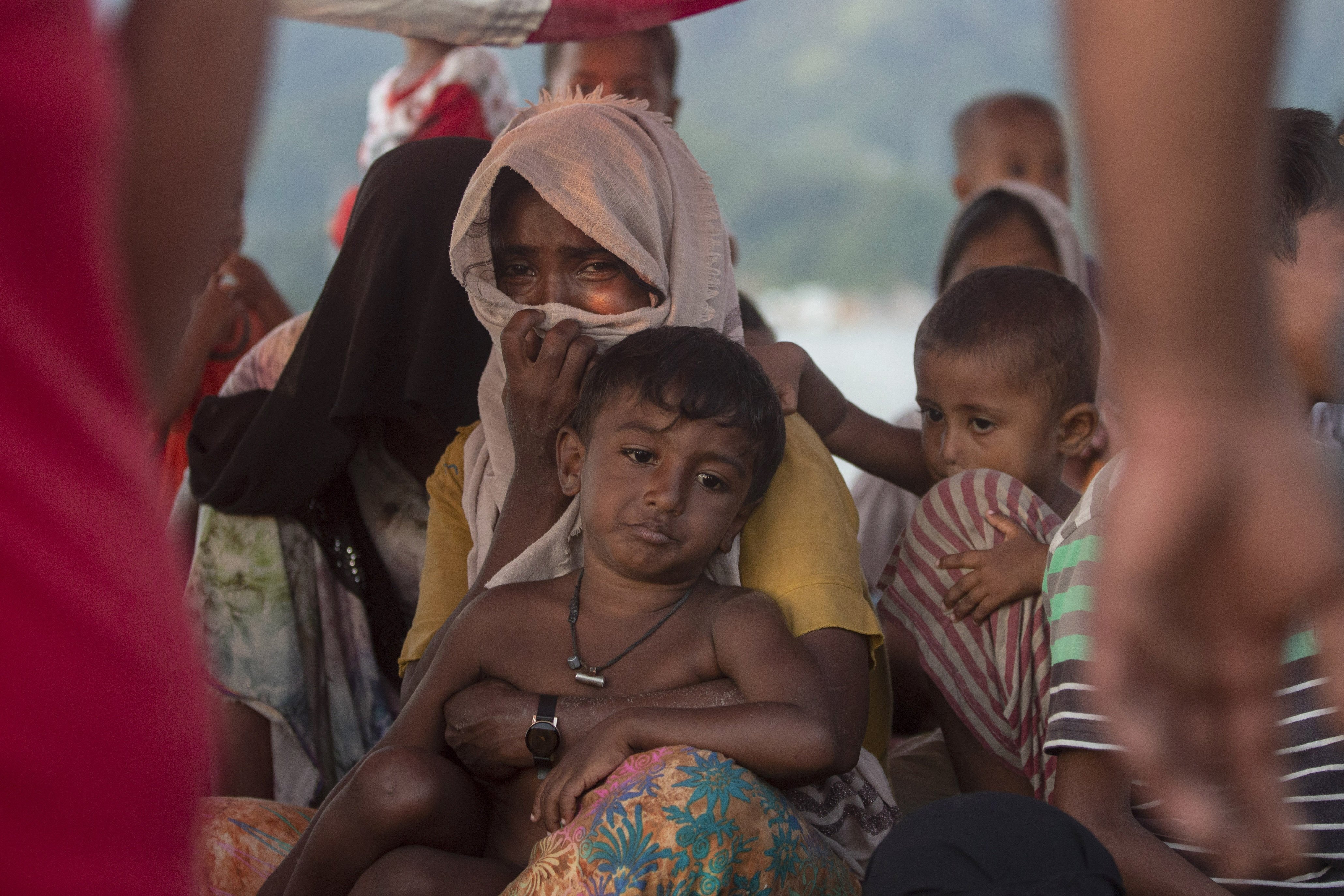 A Rohingya refugee weeps as she sits on the deck of a boat anchored in the waters near the coast of Labuhan Haji, Aceh province, Indonesia, Tuesday, Oct. 22, 2024. (AP Photo/Binsar Bakkara)