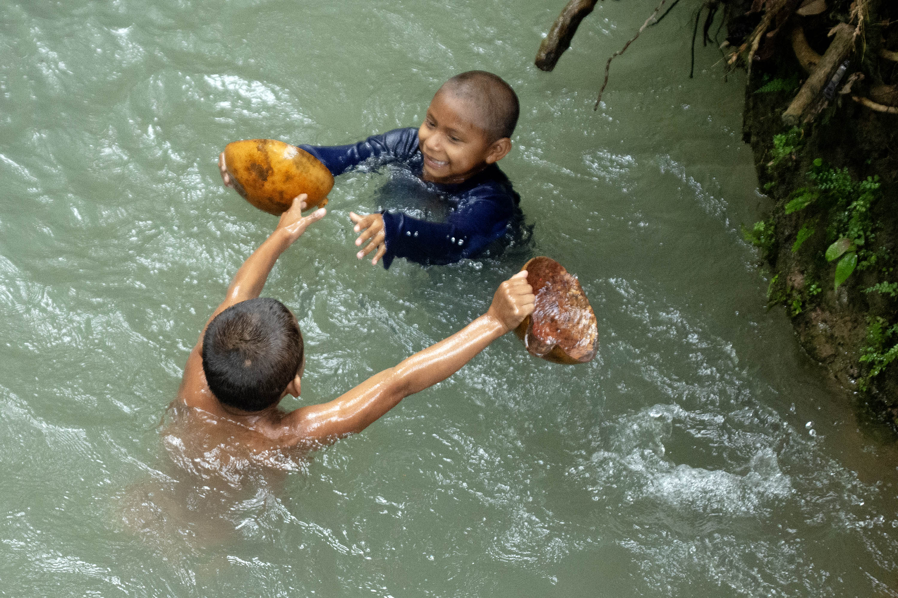 Two Nukak children play in the water