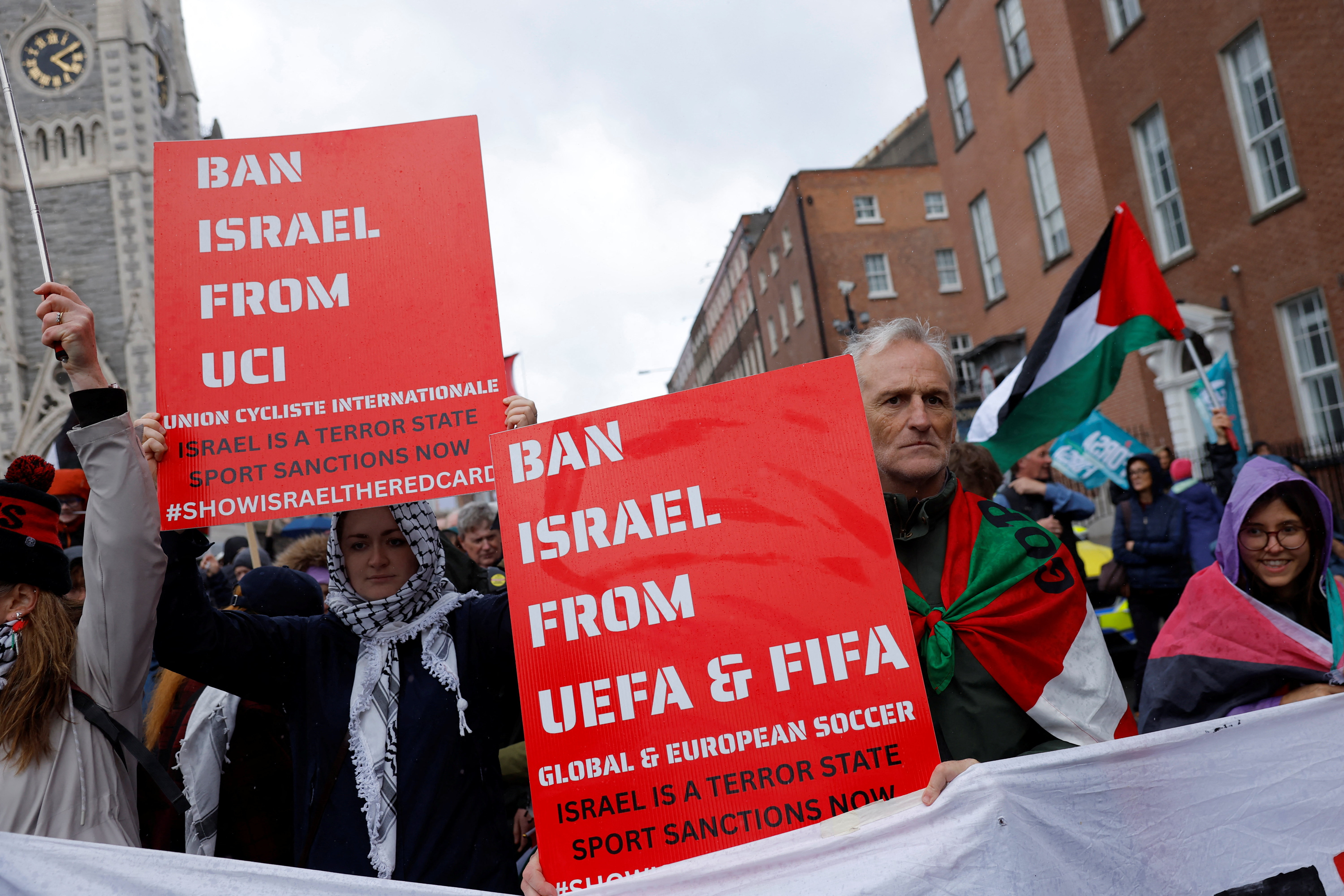 Demonstrators hold placards calling for Israel to be banned from UEFA and FIFA during a national protest in Dublin, Ireland [File: Clodagh Kilcoyne/Reuters]