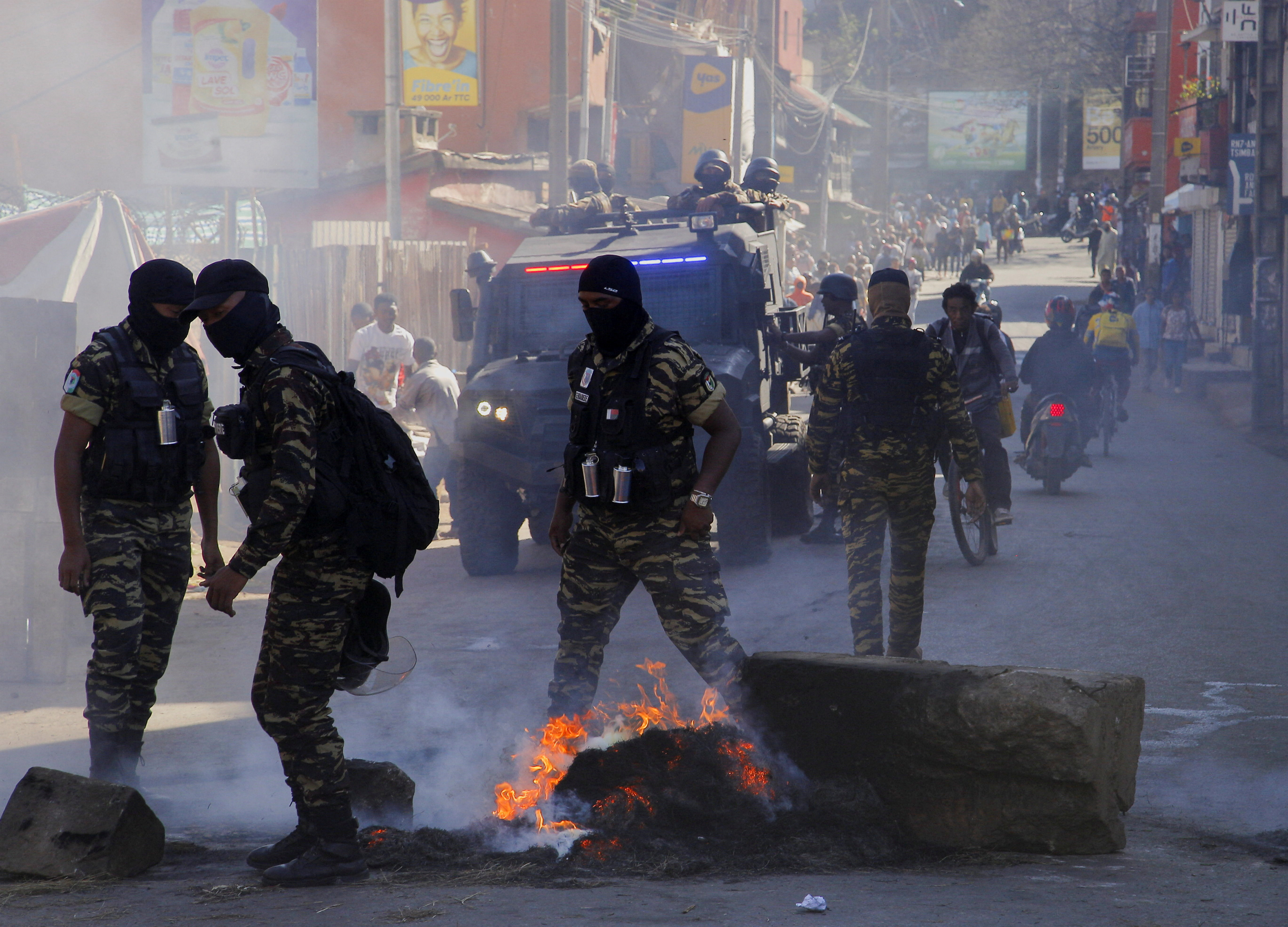 Police officers clear a burning barricade after dispersing a crowd during a nationwide youth-led protest over frequent power outages and water shortages, in Antananarivo, Madagascar, October 6, 2025. REUTERS/Zo Andrianjafy