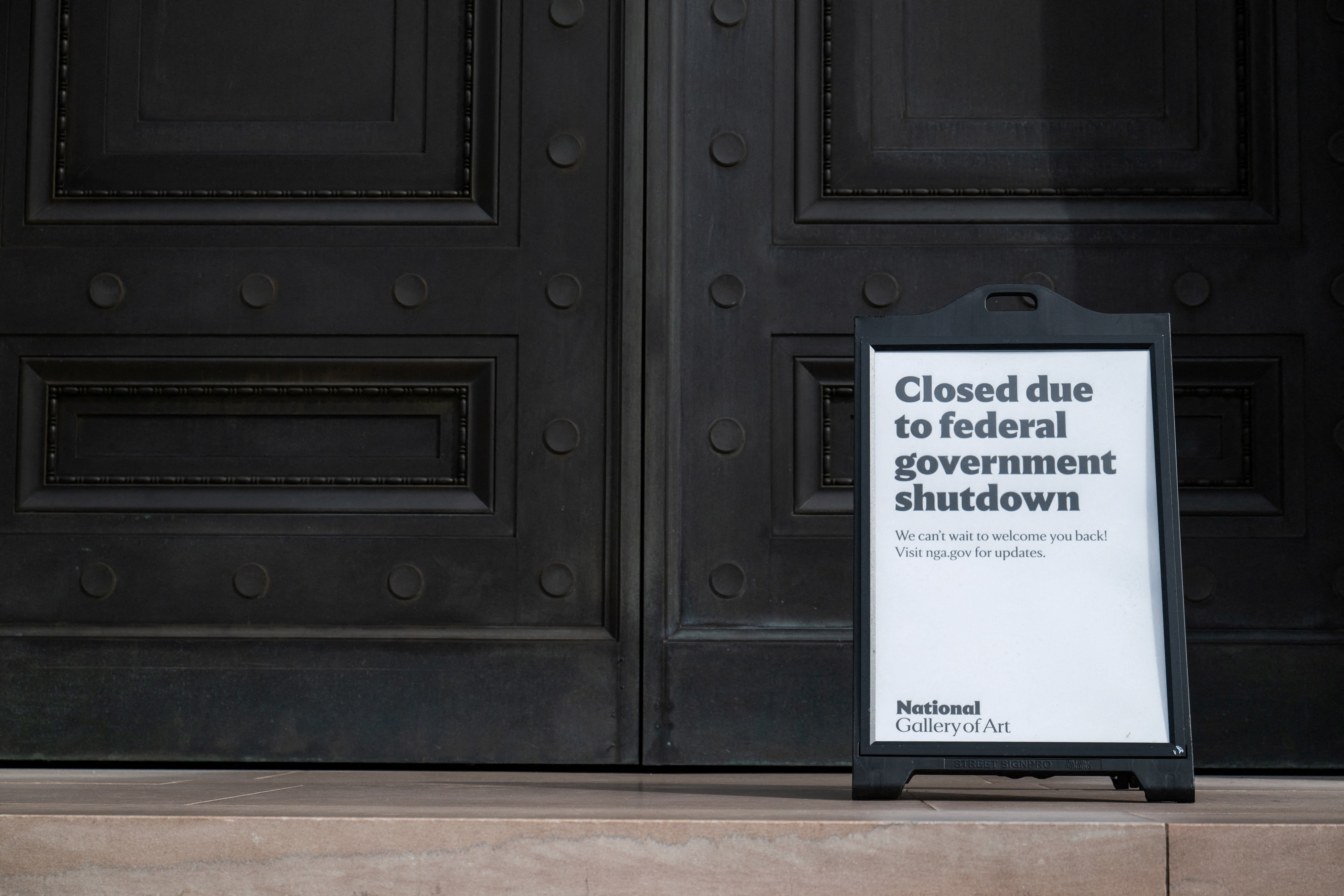 A closed sign is displayed outside the National Gallery of Art in Washington DC, USA