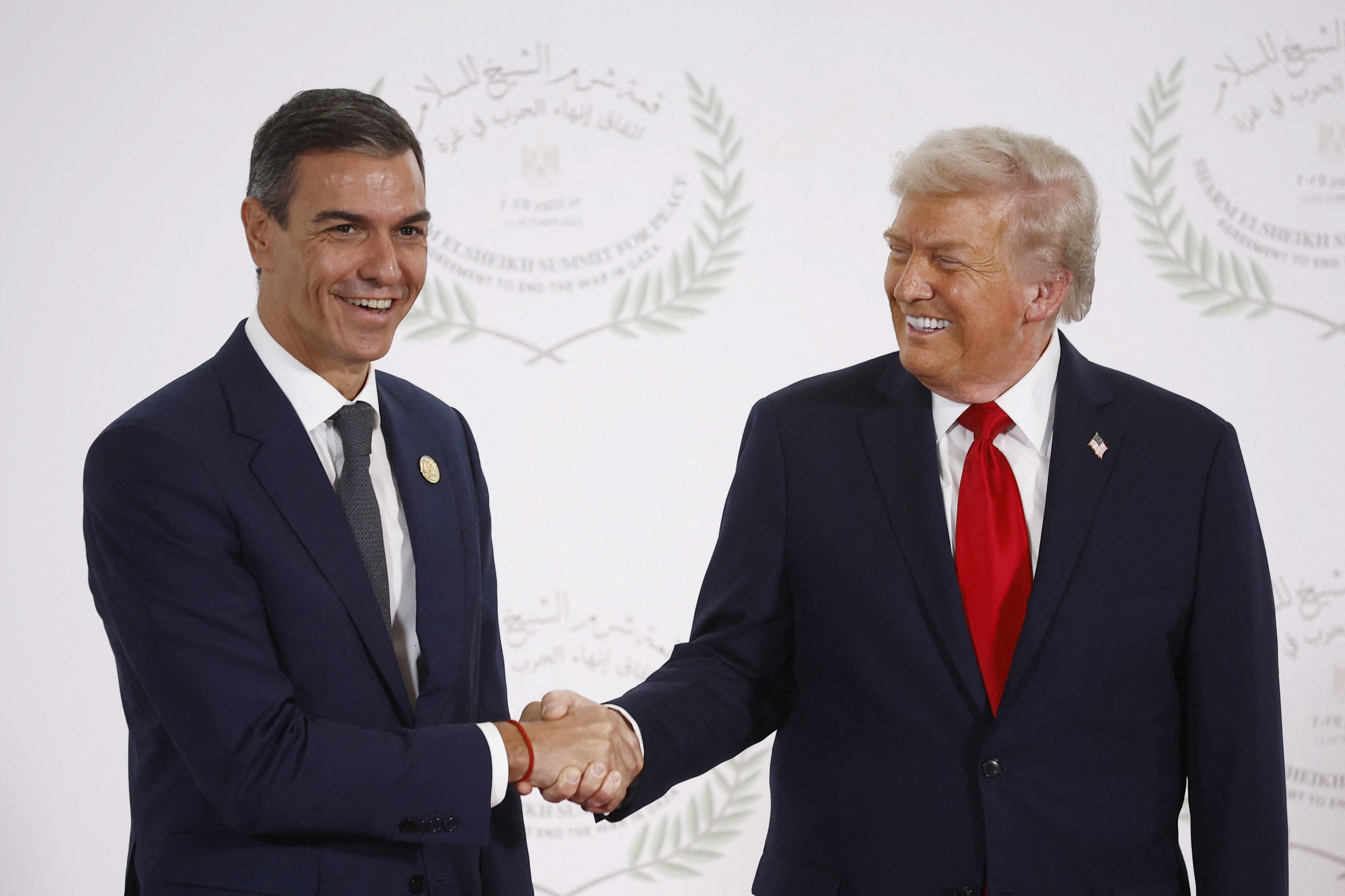 U.S. President Donald Trump and Spain's Prime Minister Pedro Sanchez shake hands as they pose for a photo, at a world leaders' summit on ending the Gaza war, amid a U.S.-brokered prisoner-hostage swap and ceasefire deal between Israel and Hamas, in Sharm el-Sheikh, Egypt, October 13, 2025. Yoan Valat/Pool via REUTERS