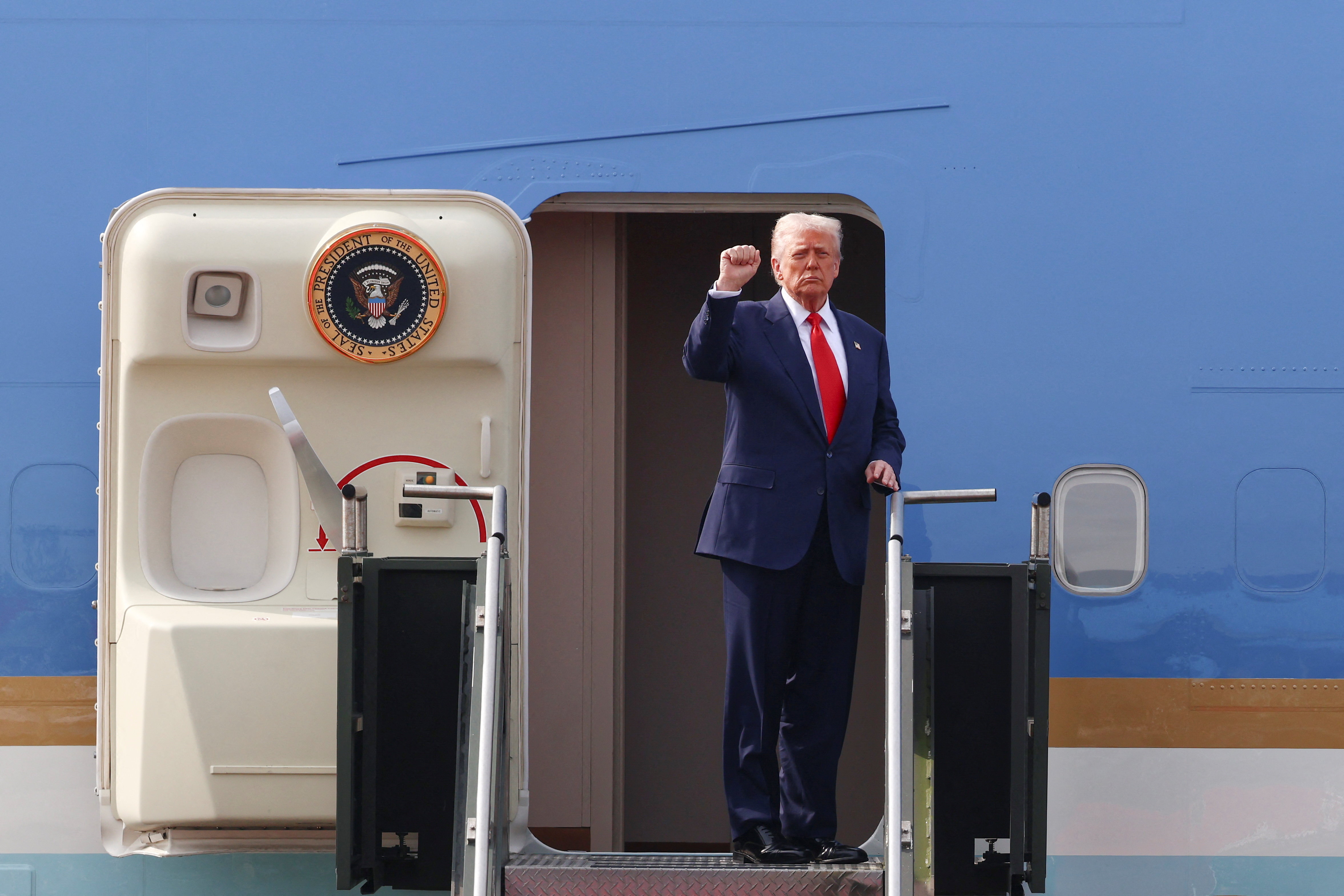 U.S. President Donald Trump gestures as he boards Air Force One at Gimhae International Airport in Busan, South Korea, October 30, 2025. REUTERS/Evelyn Hockstein