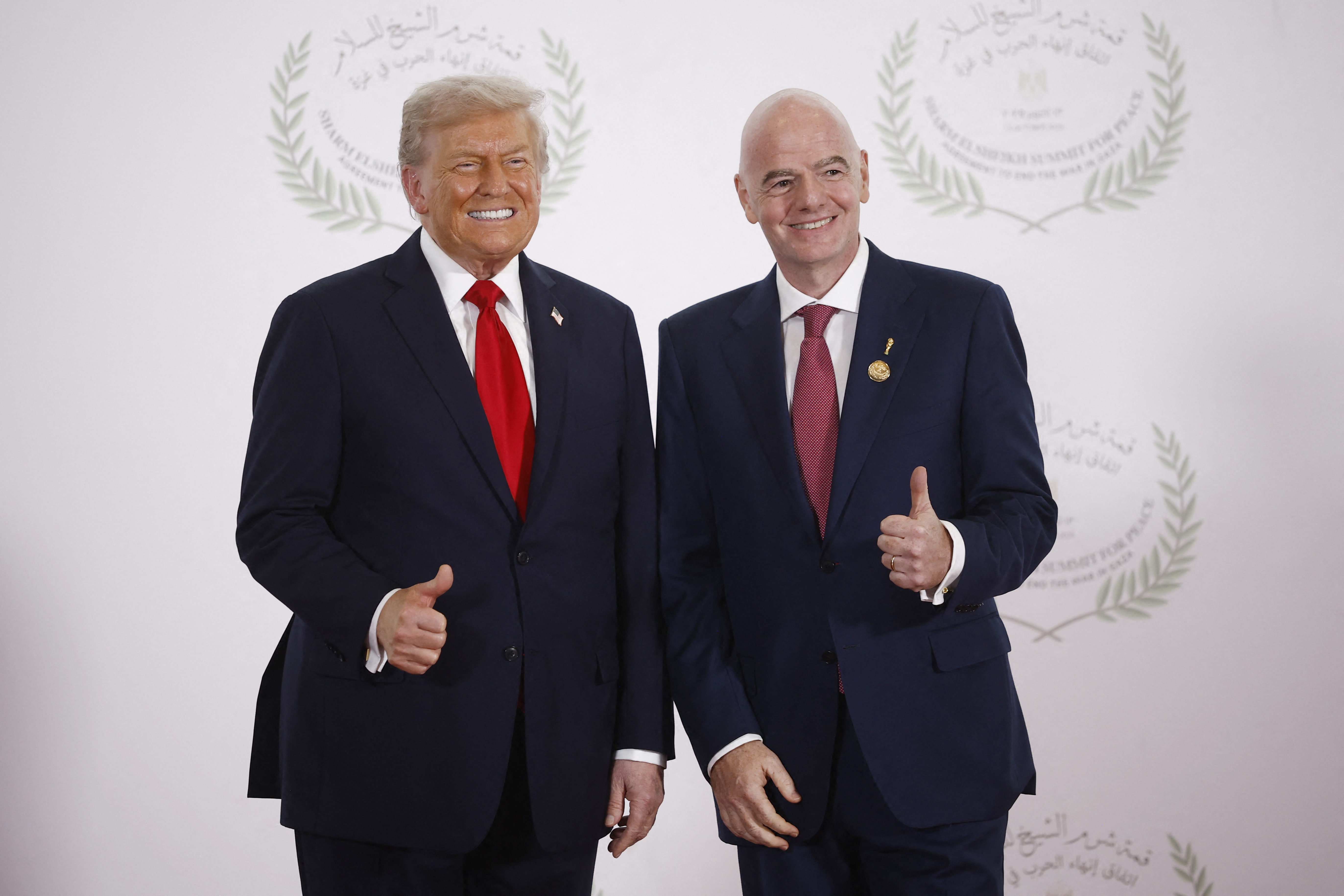 FIFA President Gianni Infantino and US President Donald Trump pose for a photo while making thumb-up signs.