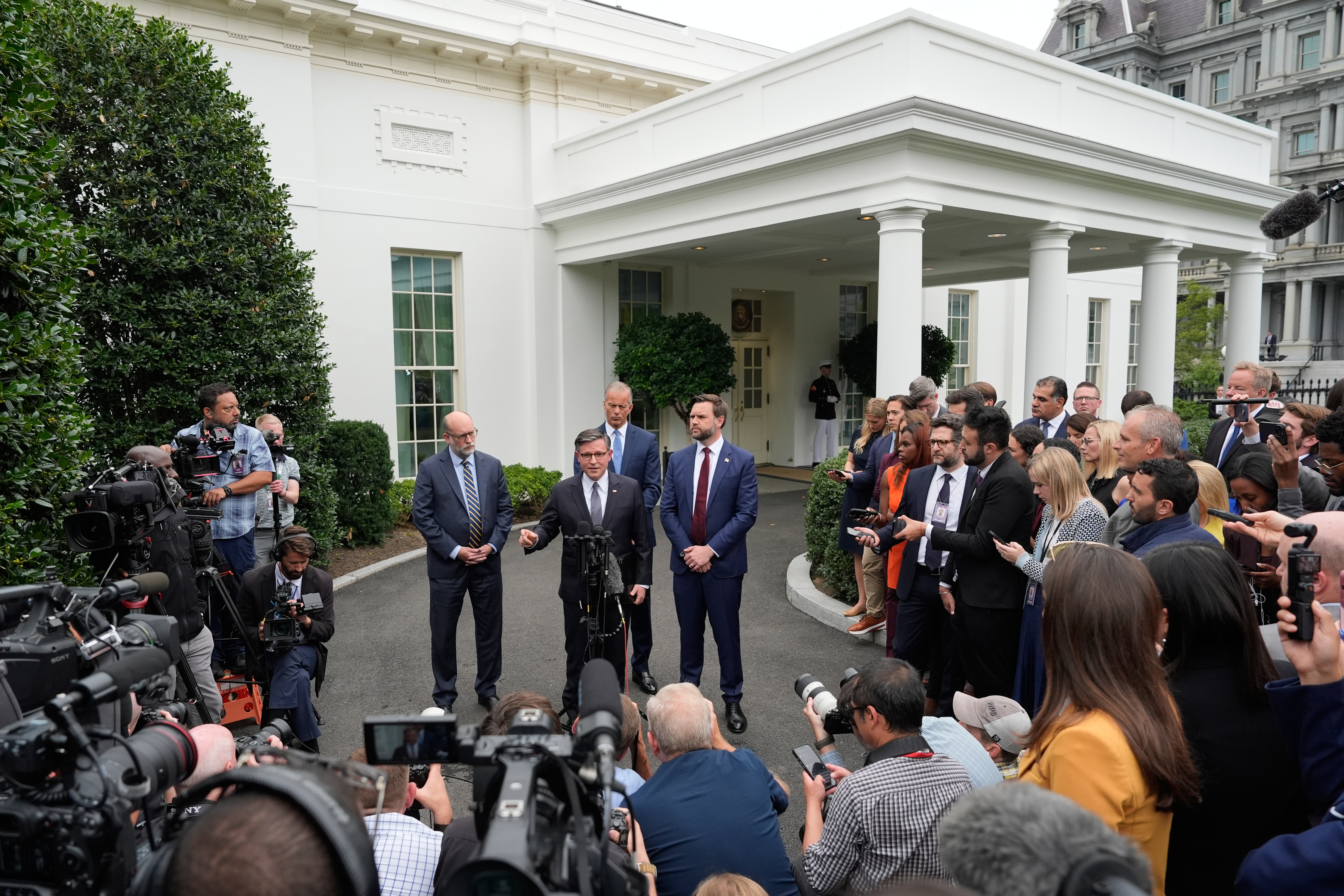 Mike Johnson speaks to reporters outside the White House.