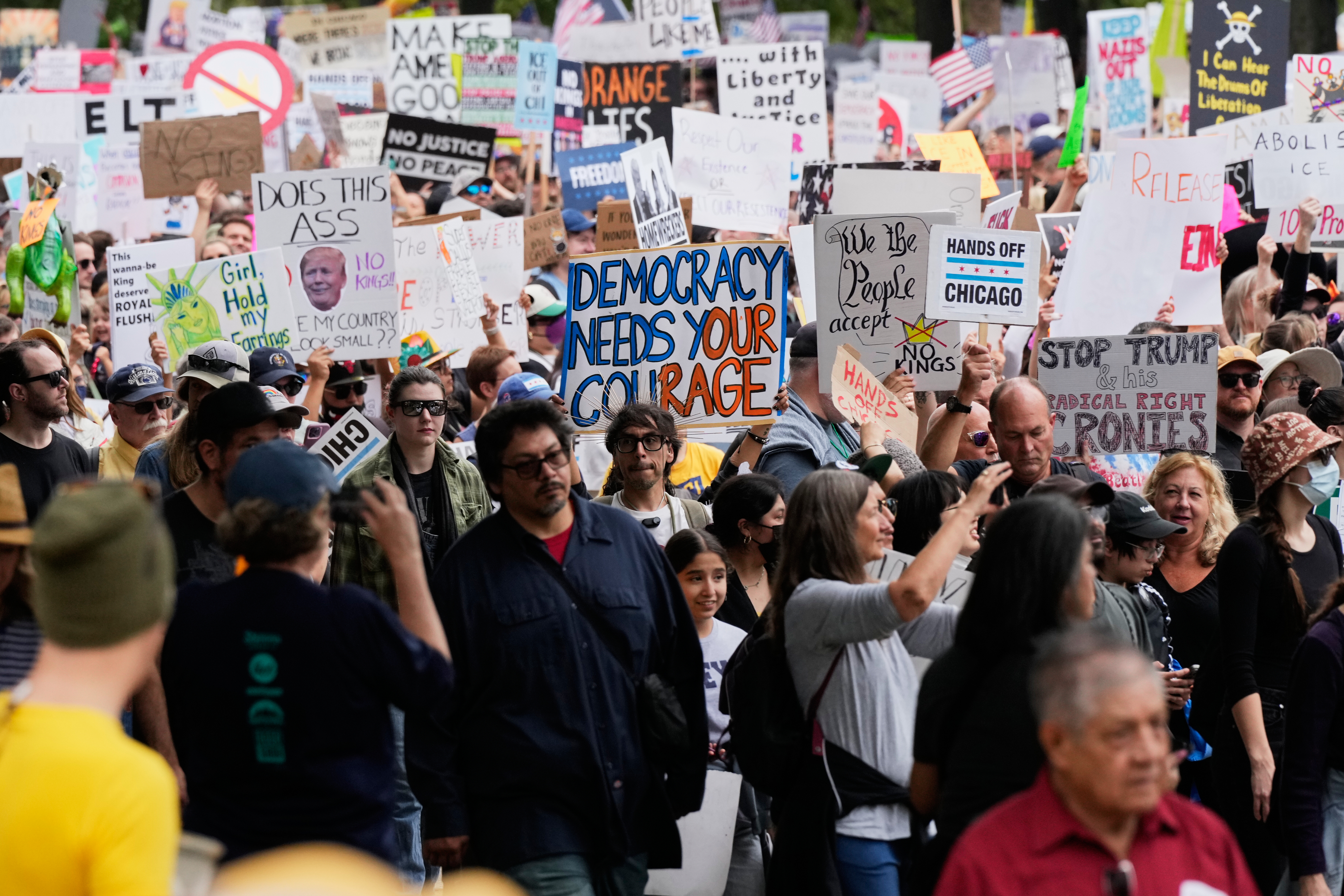 Protesters wave signs at a No Kings rally in Chicago