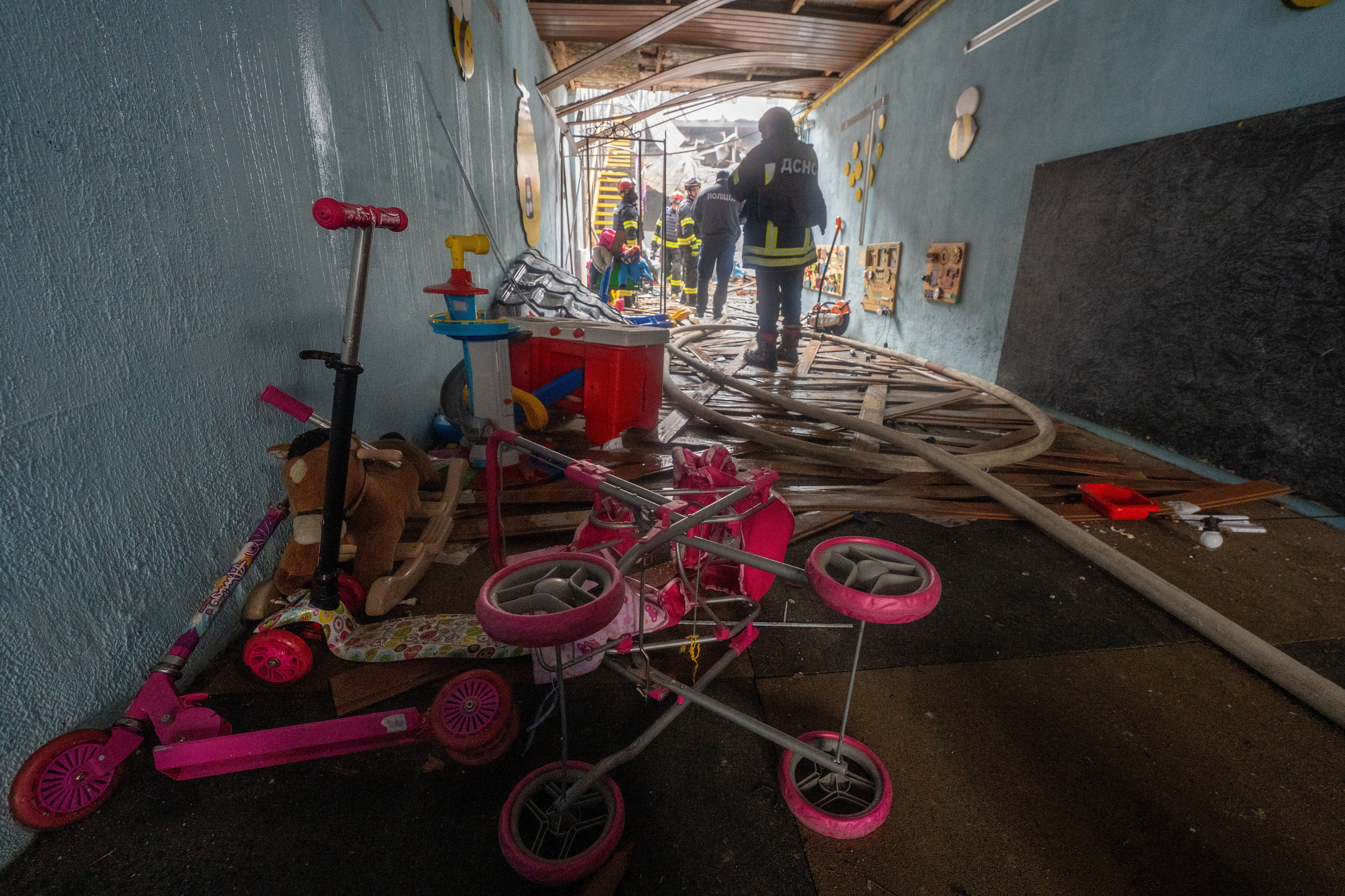 Police and firefighters inspect damage after Russian drones hit a city kindergarten during an air attack in Kharkiv, Ukraine, Wednesday, Oct. 22, 2025. (AP Photo/Andrii Marienko)
