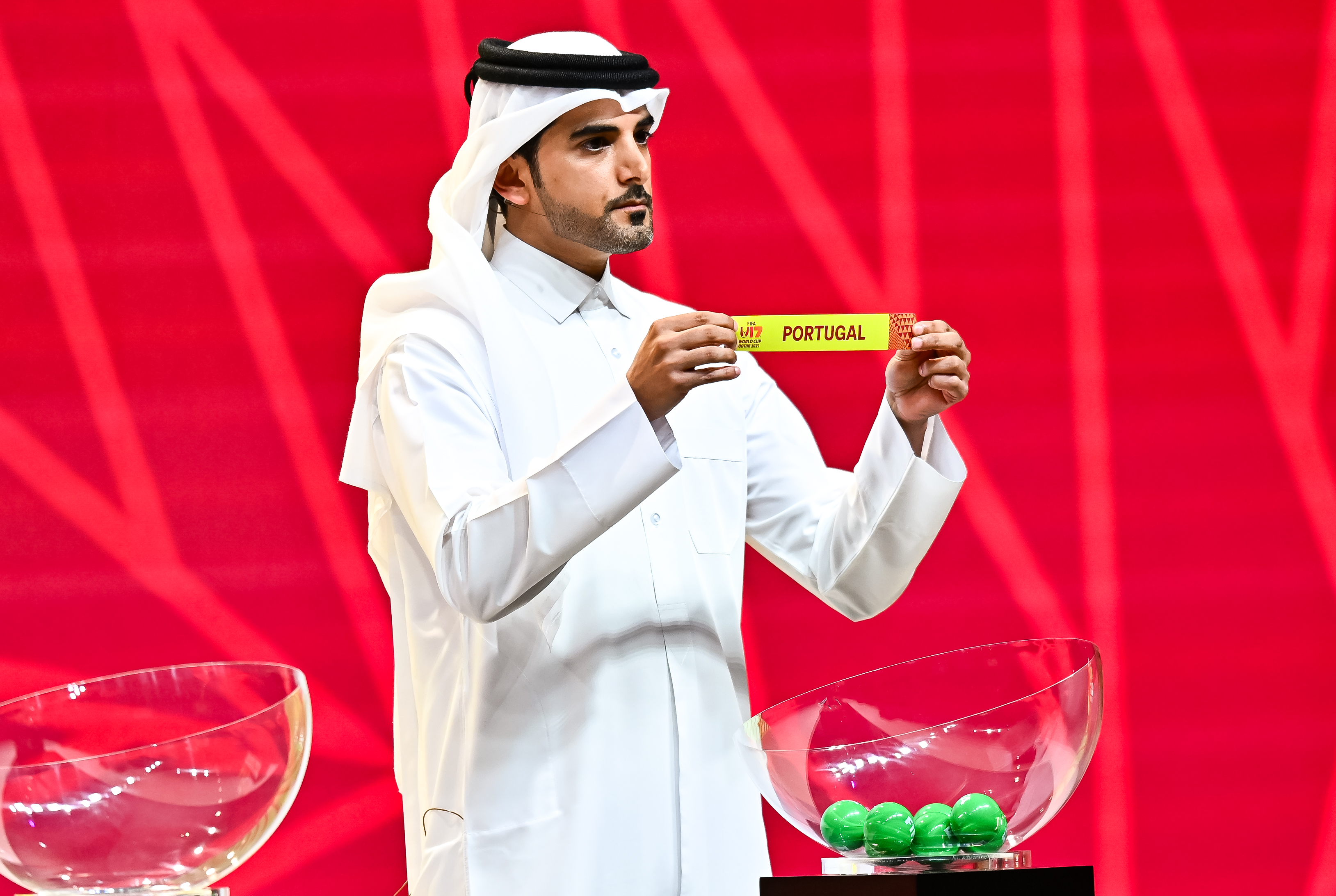 Abdulaziz Al-Sulaiti, a former Qatari footballer, shows a result paper bearing the name of Portugal during the FIFA U-17 World Cup Qatar 2025 Finals Draw in Doha, Qatar, on May 25, 2025. (Photo by Noushad Thekkayil/NurPhoto via Getty Images)