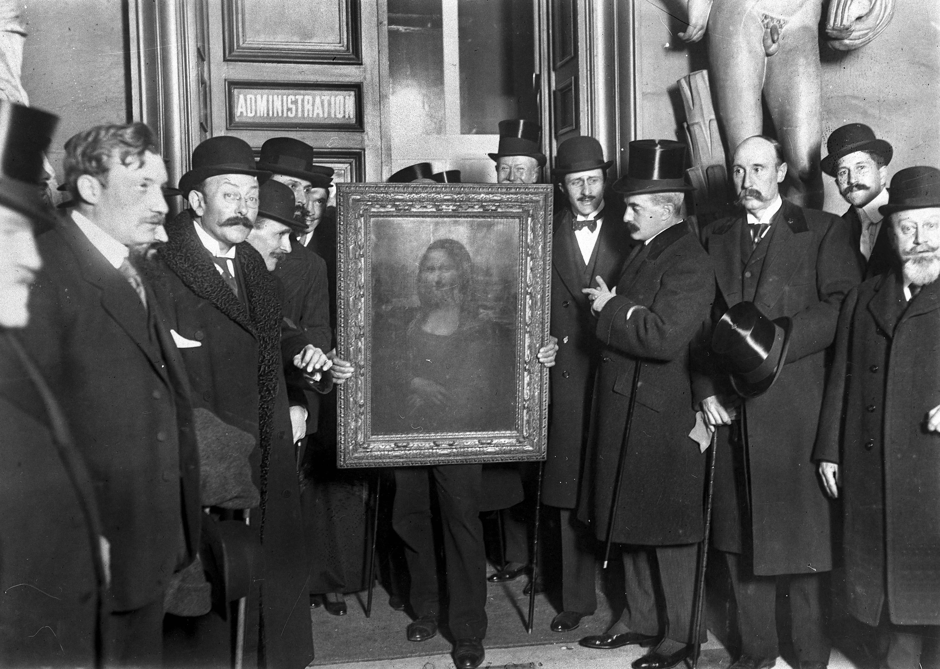 People gather around the Mona Lisa painting on January 4, 1914 in Paris France, after it was stolen from the Musee du Louvre by Vincenzo Peruggia in 1911.