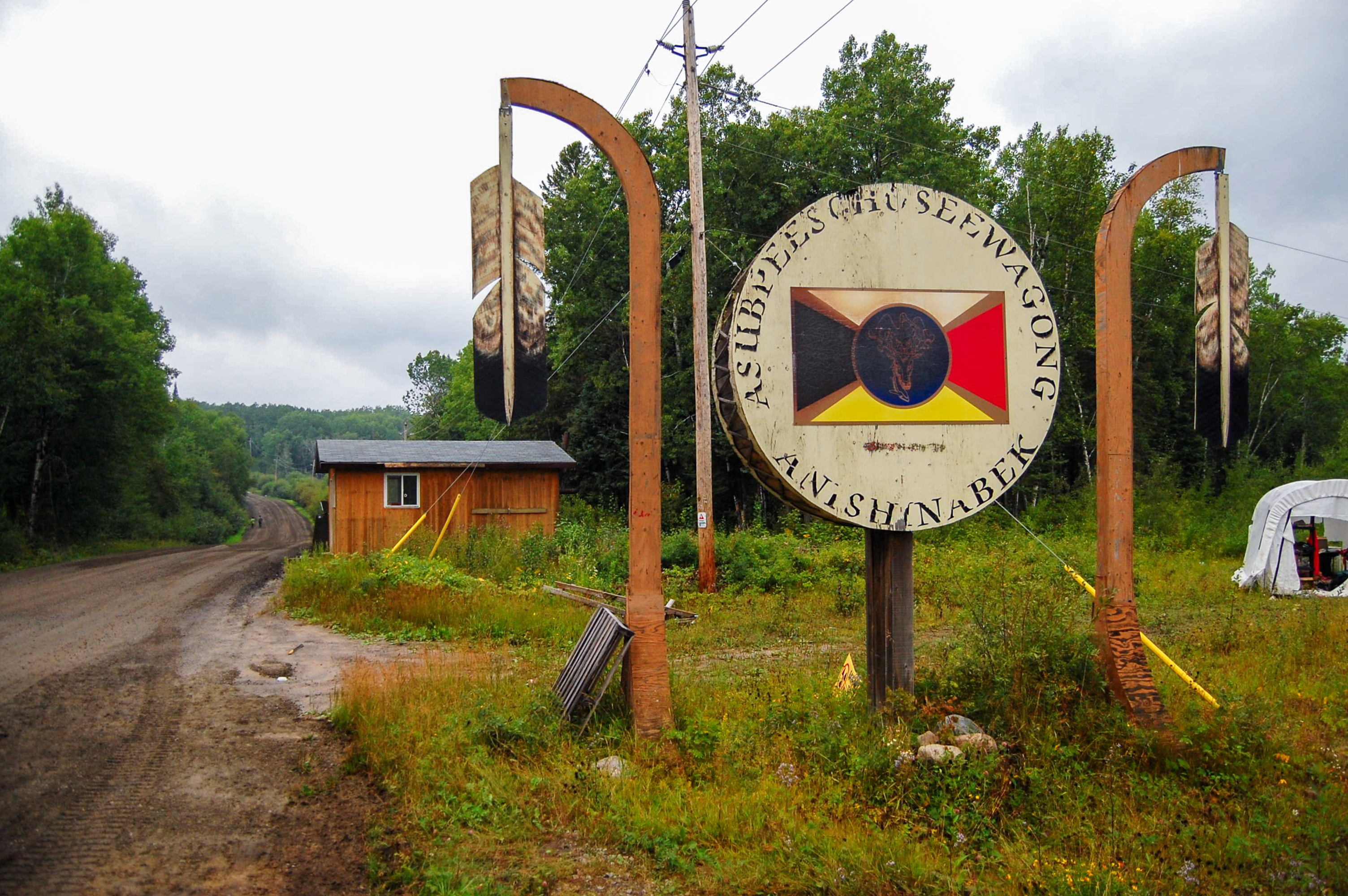 A drum and wooden feathers mark the entrance to Grassy Narrows First Nation in northwestern Ontario, Canada