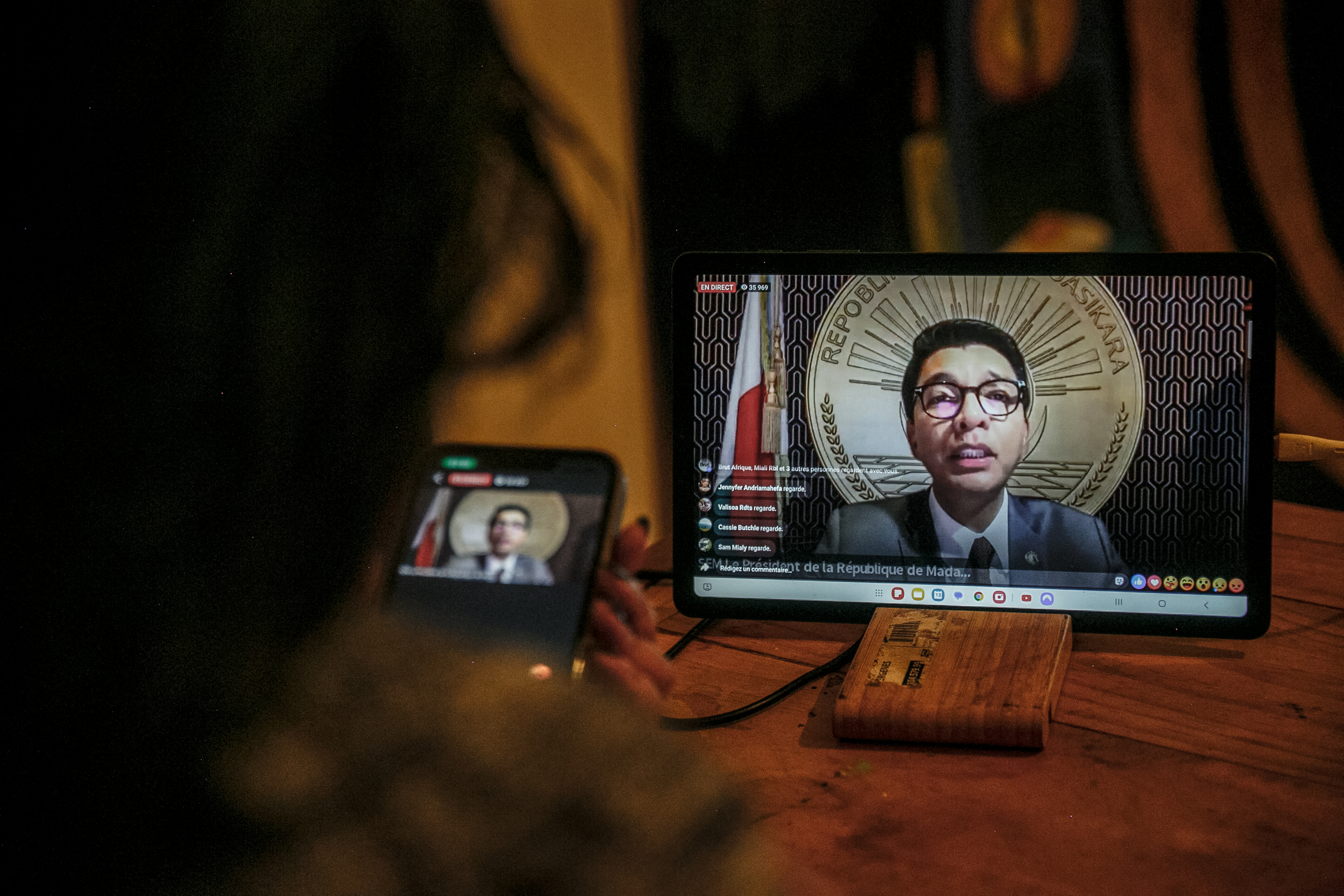 A resident of Antananarivo watches Madagascar President Andry Rajoelina’s address to the nation via the official Facebook page of the Presidency of Madagascar, from her home in Antananarivo on October 13, 2025.