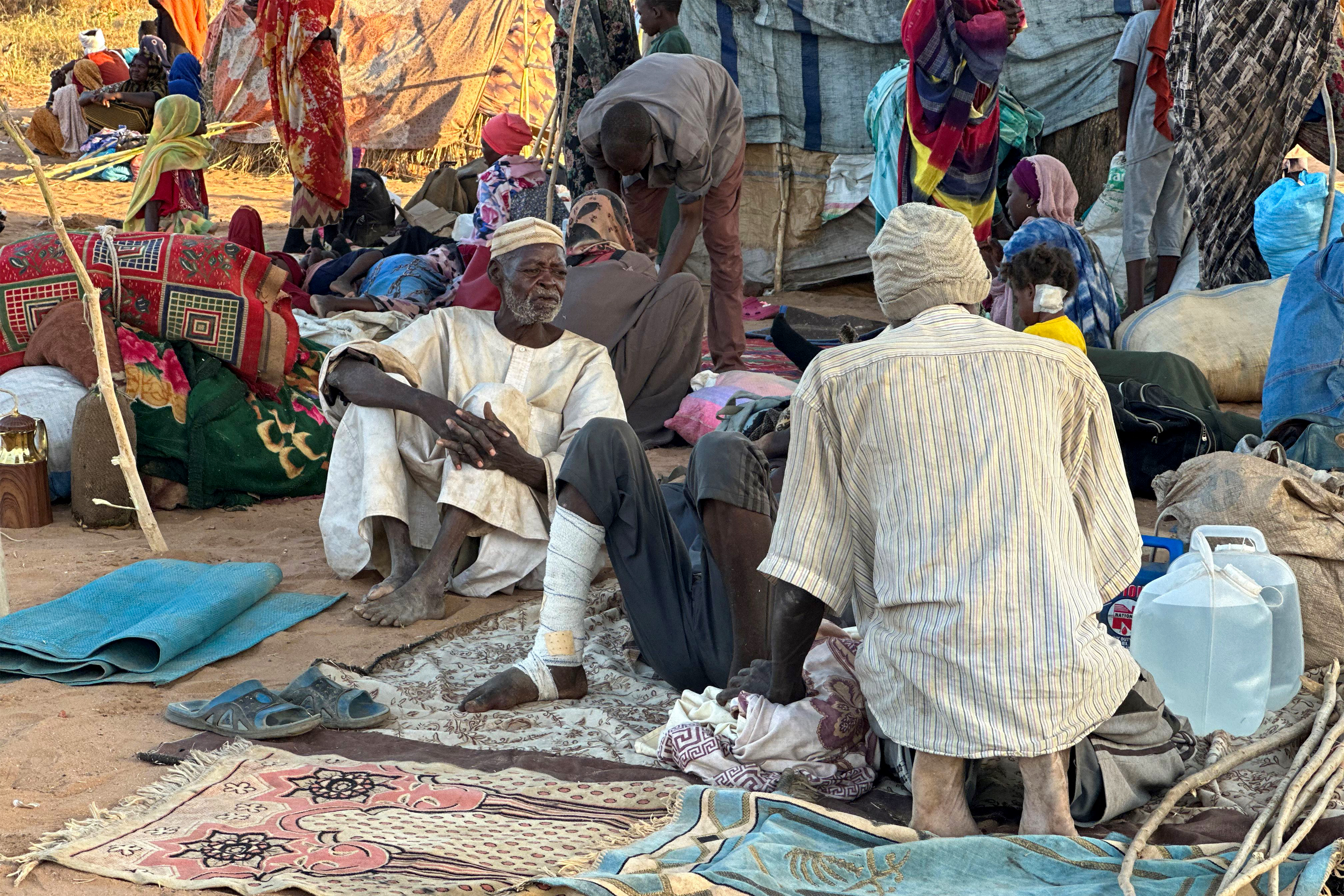 Displaced Sudanese who fled El-Fasher after the city fell to the Rapid Support Forces (RSF), rest near the town of Tawila in war-torn Sudan's western Darfur region on October 28, 2025.