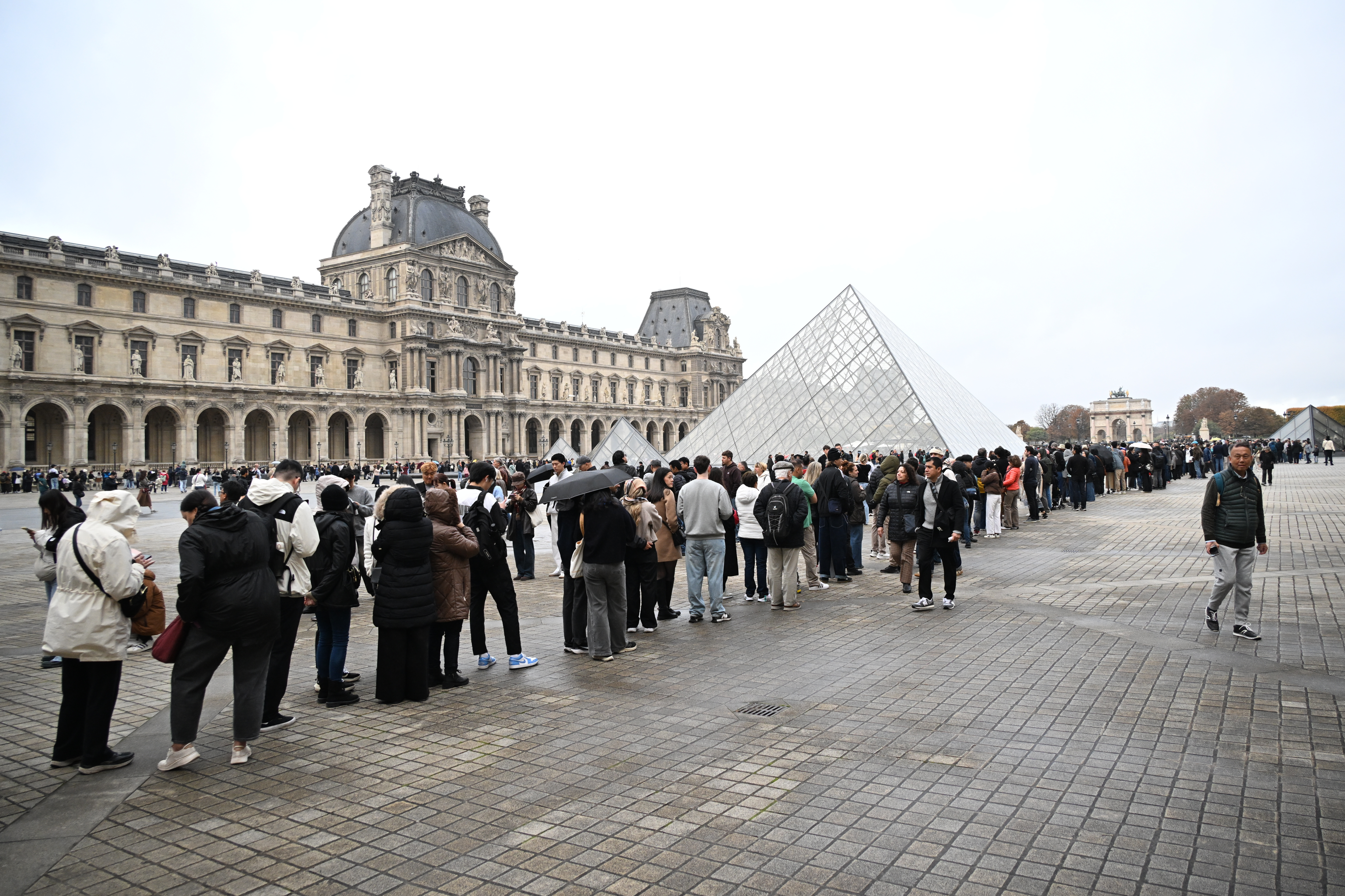 People queue outside the Louvre museum in Paris