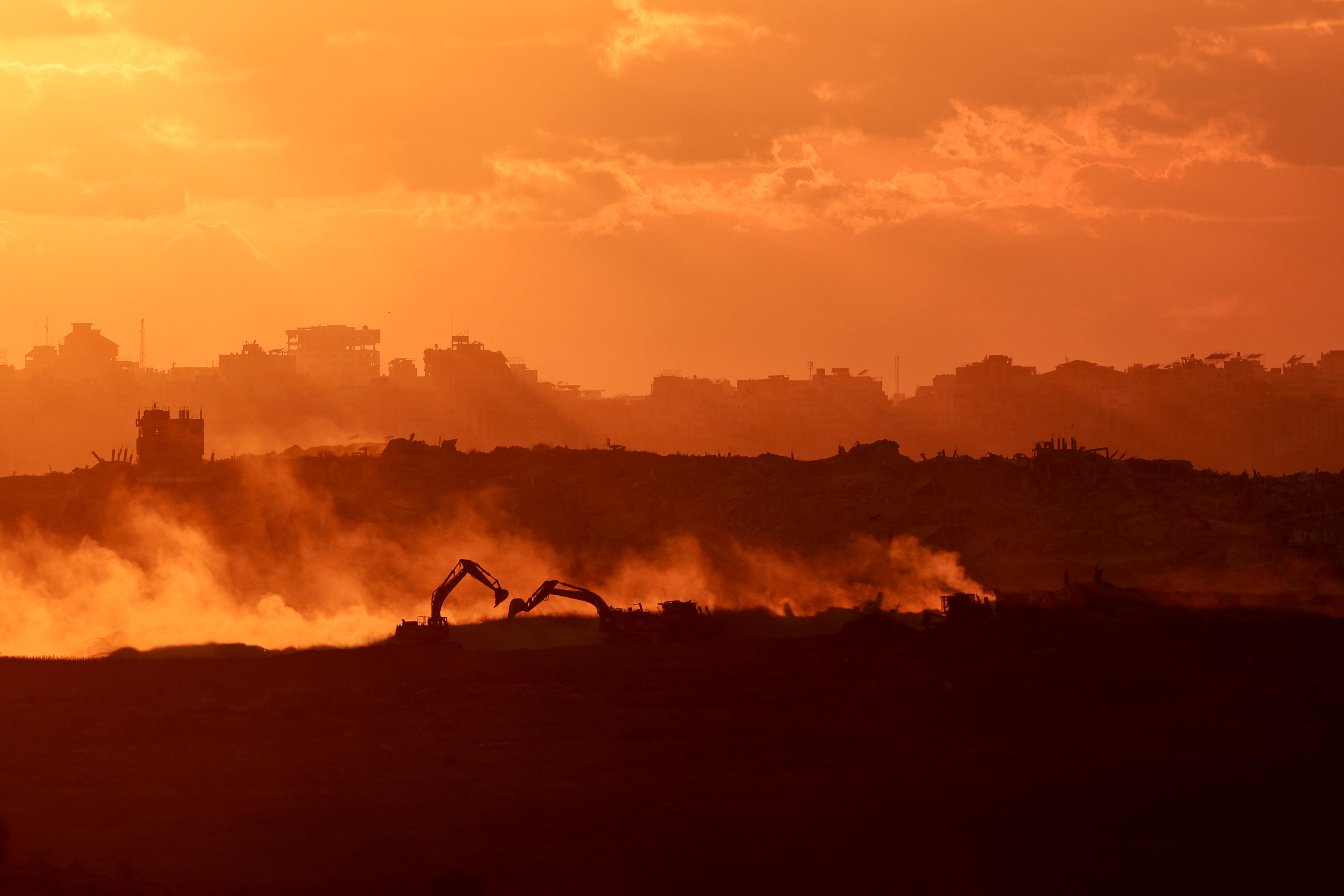 epa12453509 Israeli troops moving in the northern part of the Gaza Strip as seen form the Israeli side of the border near the town of Sderot, following the Israel-Hamas agreement , 14 October 2025, EPA/ATEF SAFADI