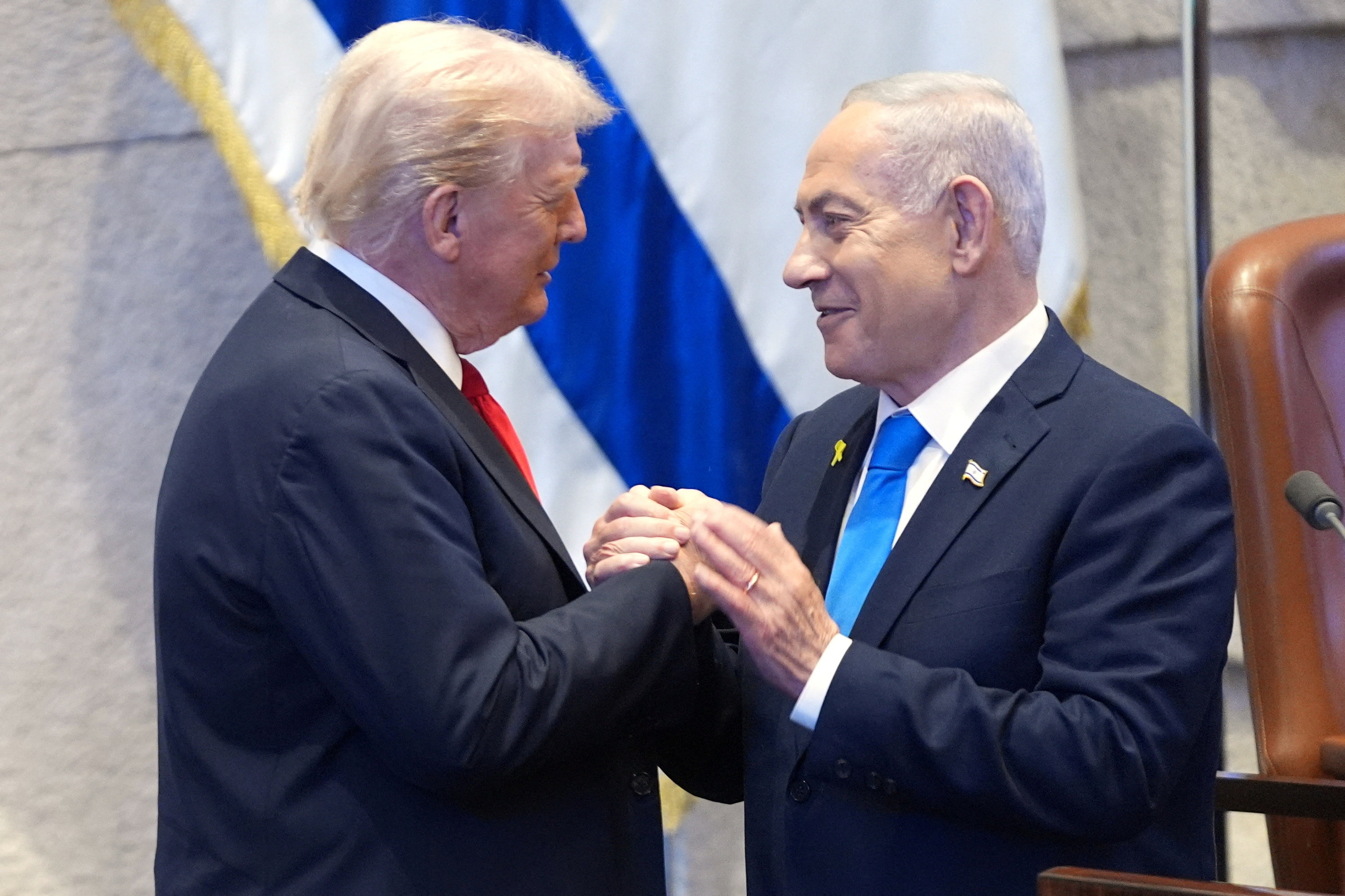President Donald Trump talks with Israel's Prime Minister Benjamin Netanyahu at the Knesset, Monday, Oct. 13, 2025, in Jerusalem. Evan Vucci/Pool via REUTERS