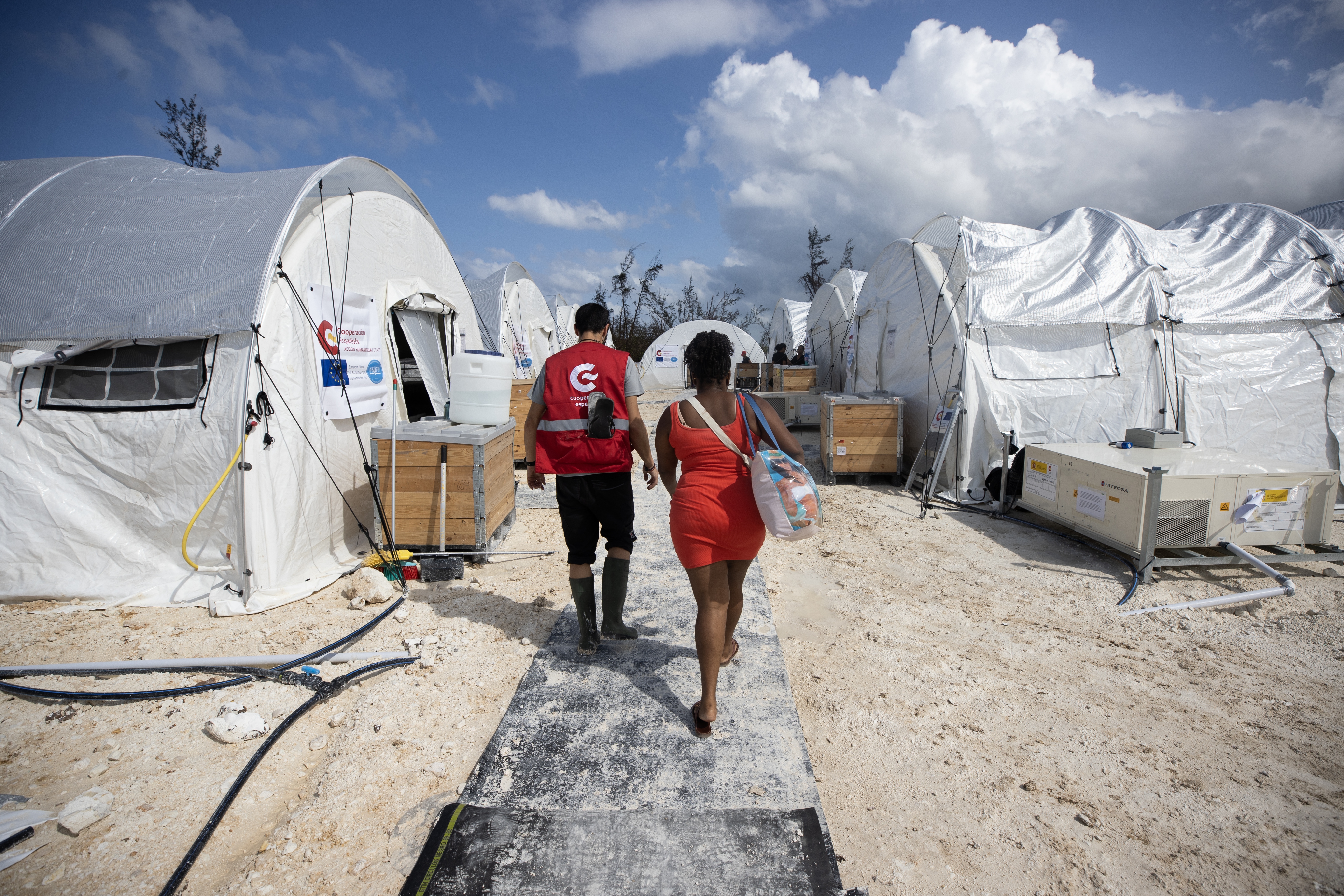 A healthcare worker walks with a person at the Spanish field hospital in Falmouth, Jamaica