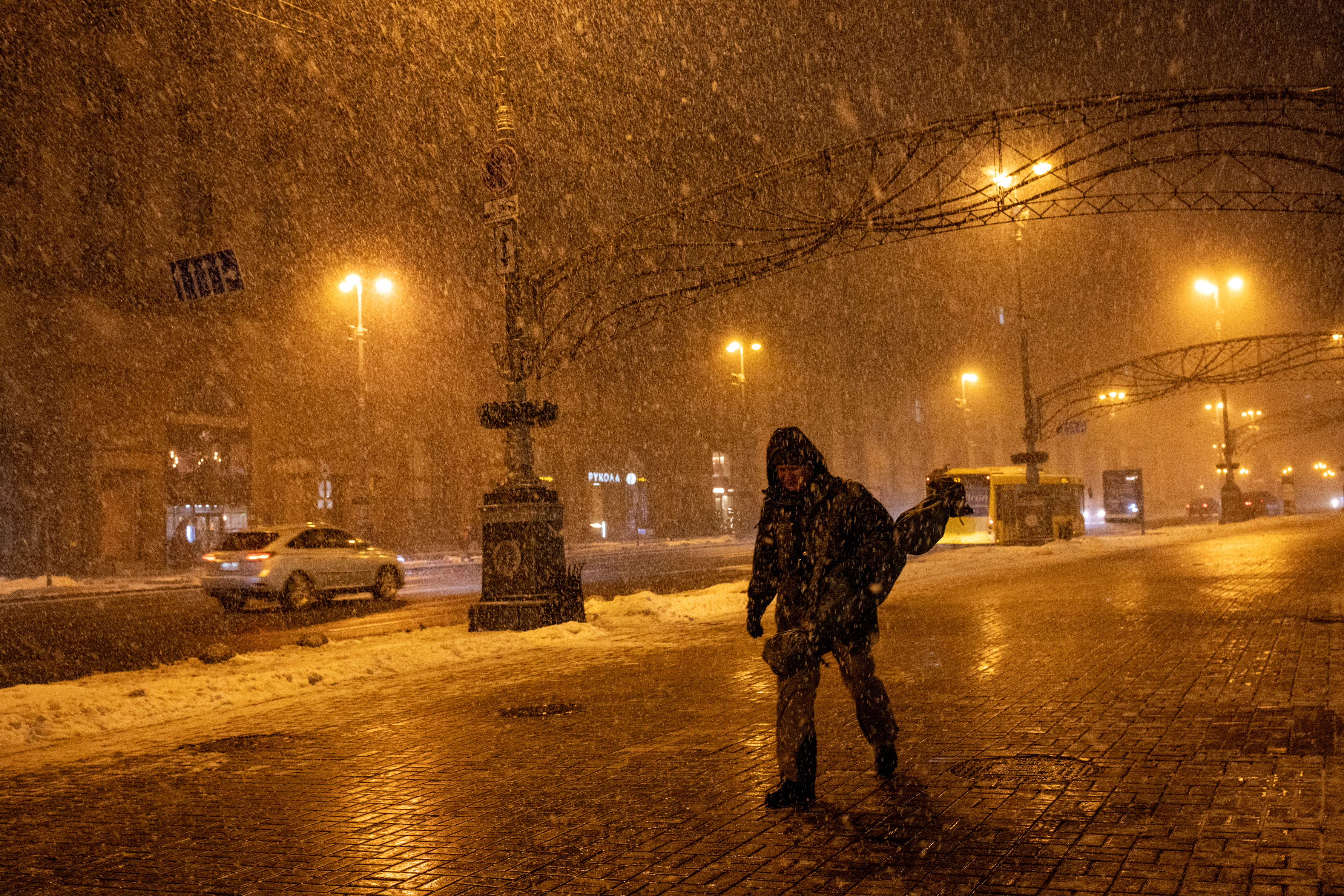 A man walks in Khreshchatyk street during a snow storm, amid Russia’s attack on Ukraine, in central Kyiv, Ukraine, February 19, 2025. REUTERS/Thomas Peter