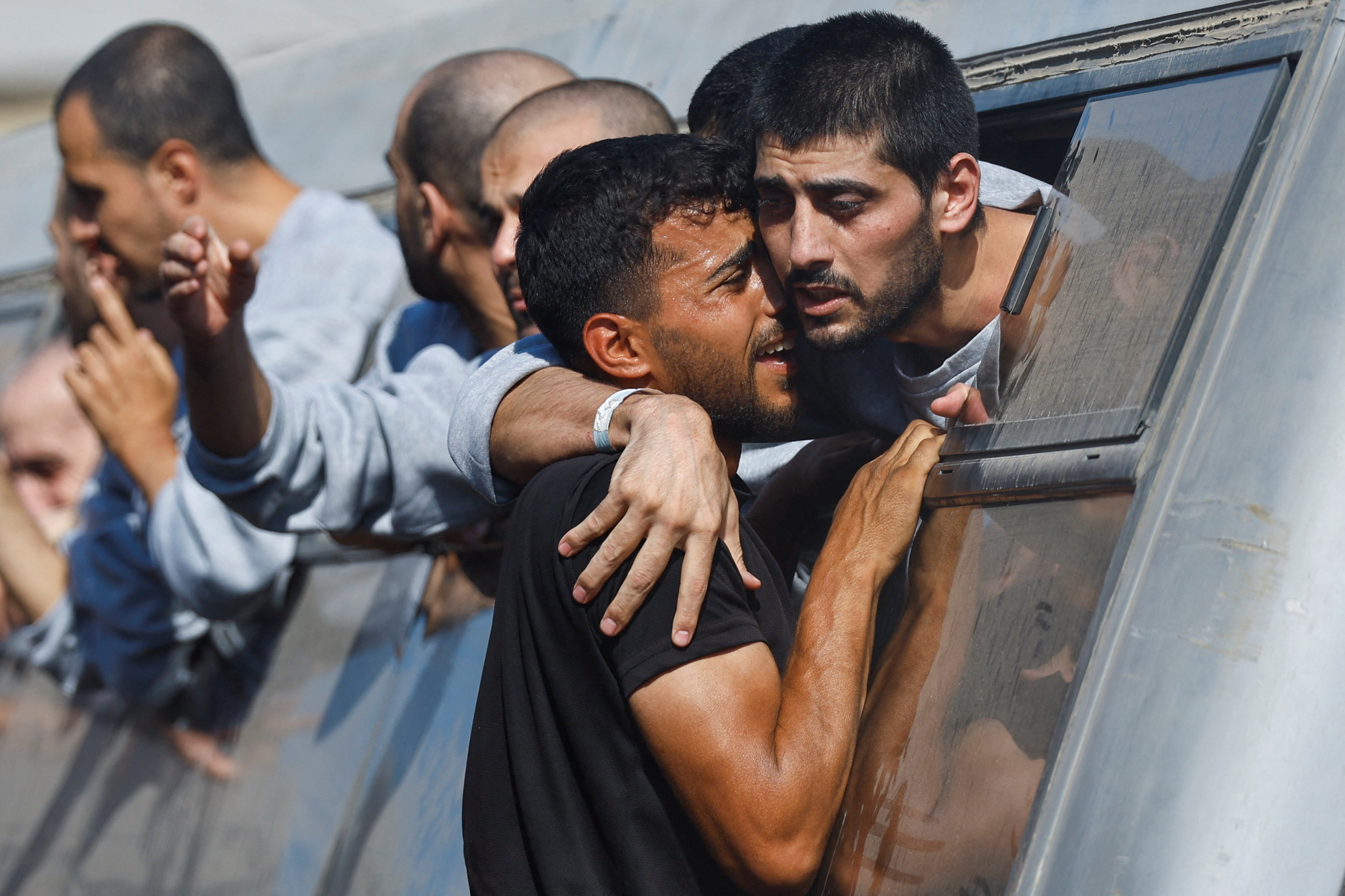 A man greets a freed Palestinian detainee released as part of the Gaza ceasefire deal