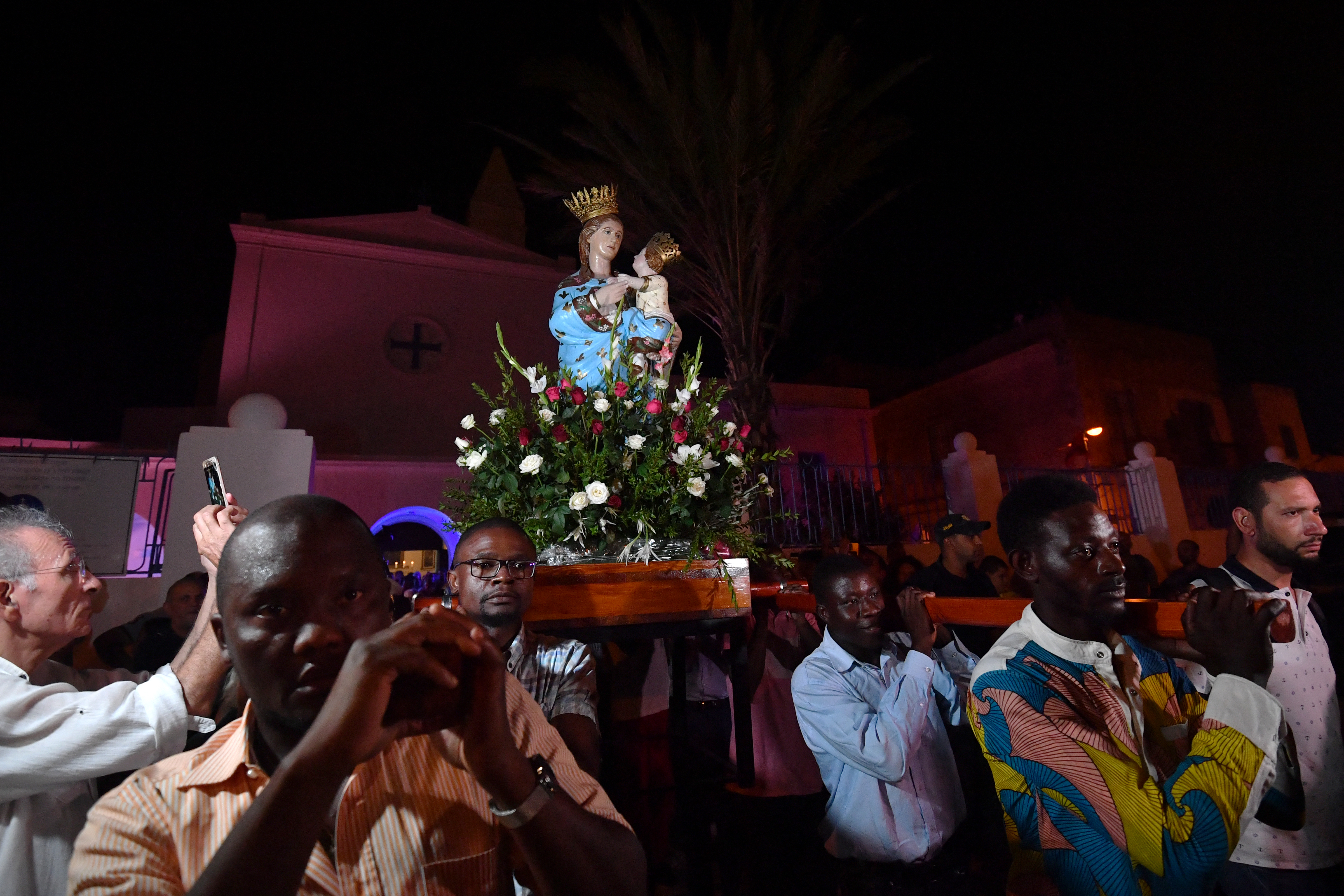 Worshippers carry the shrine of the Madonna of Trapani