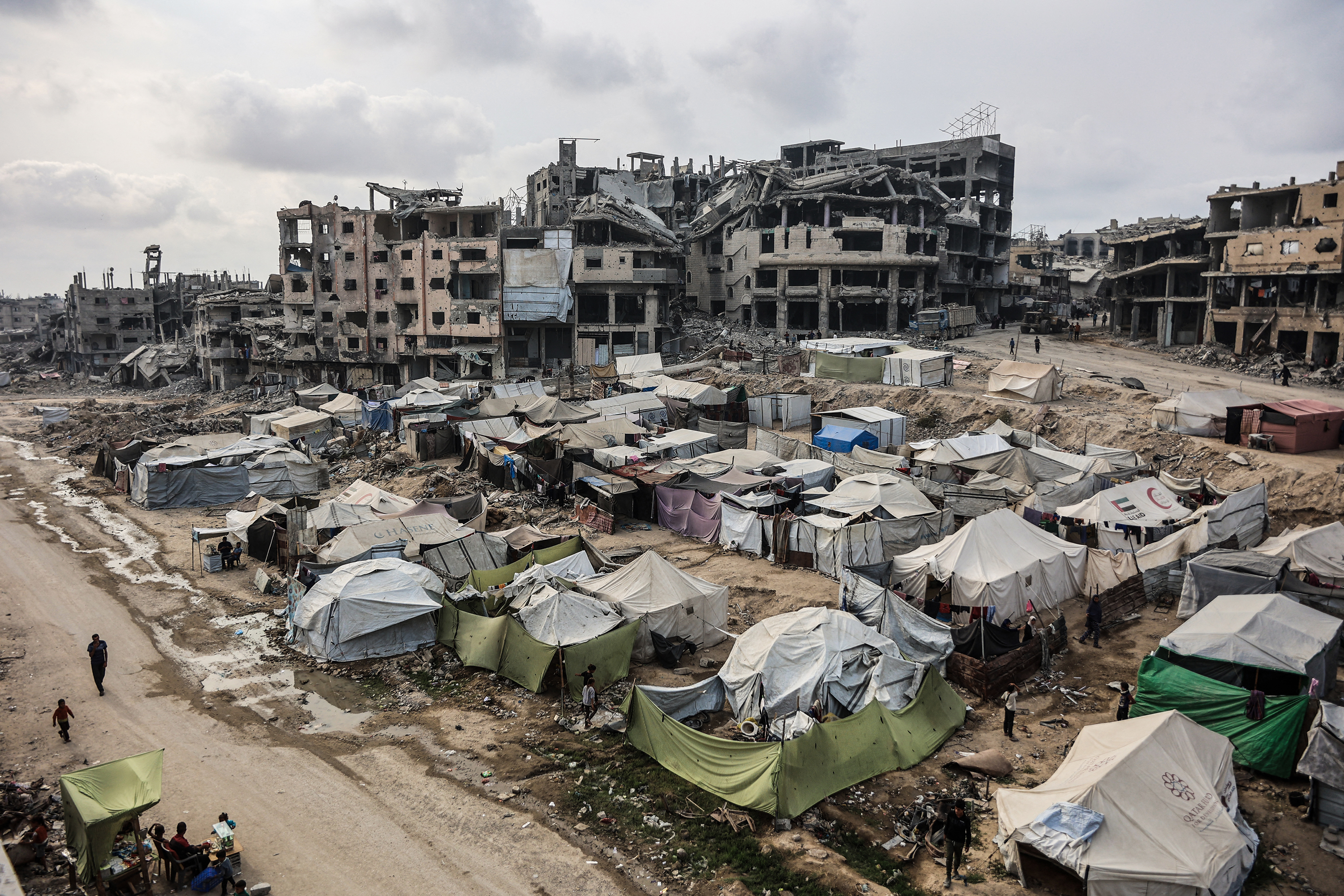 Palestinians walk around their tents in Gaza City on November 3, 2025, during a ceasefire in the two-year-long Israeli war on Gaza. [File: Omar Al-Qattaa/AFP]