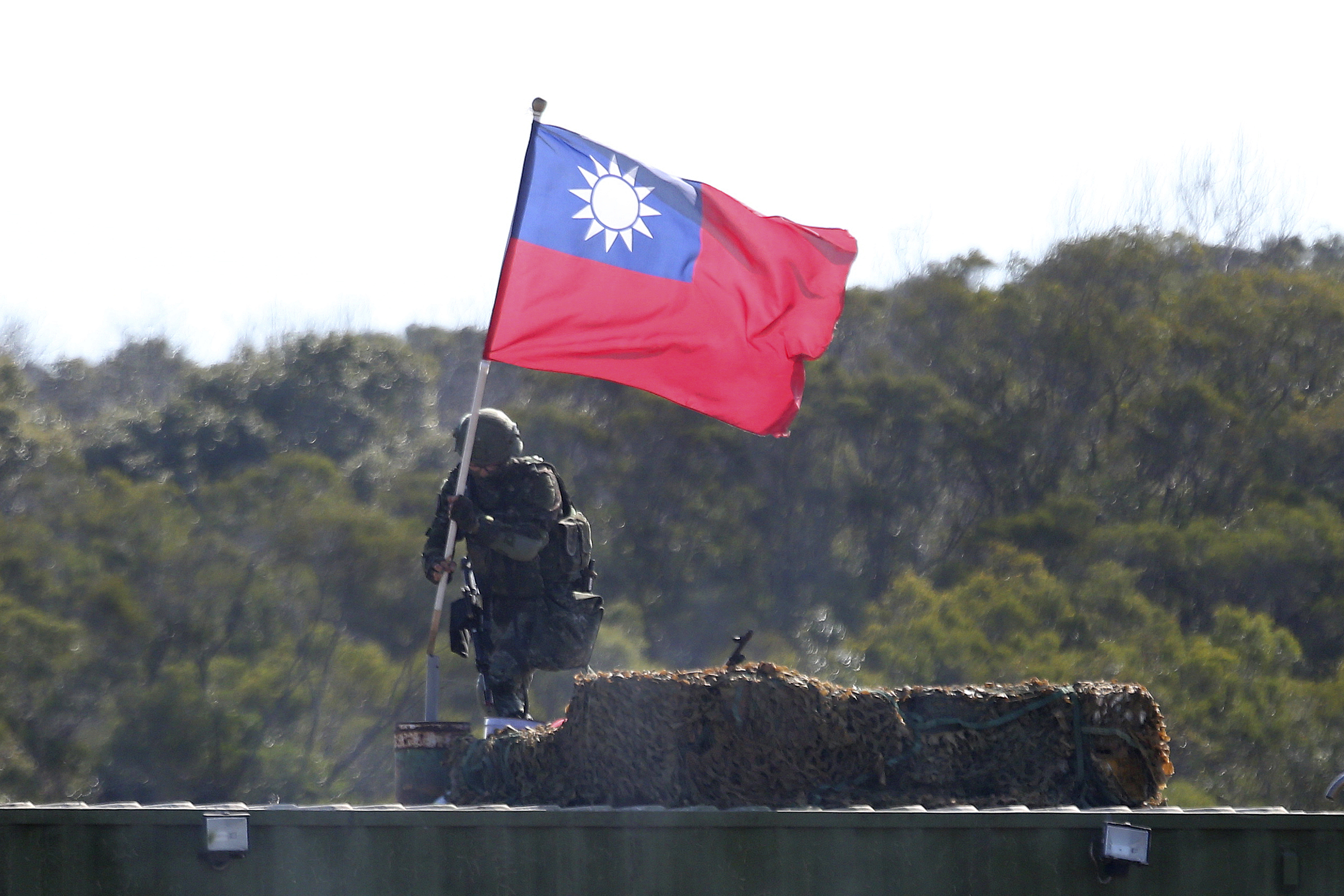 A soldier holds a Taiwanese flag during a military exercise aimed at repelling an attack from China in Hsinchu County, northern Taiwan, in 2021