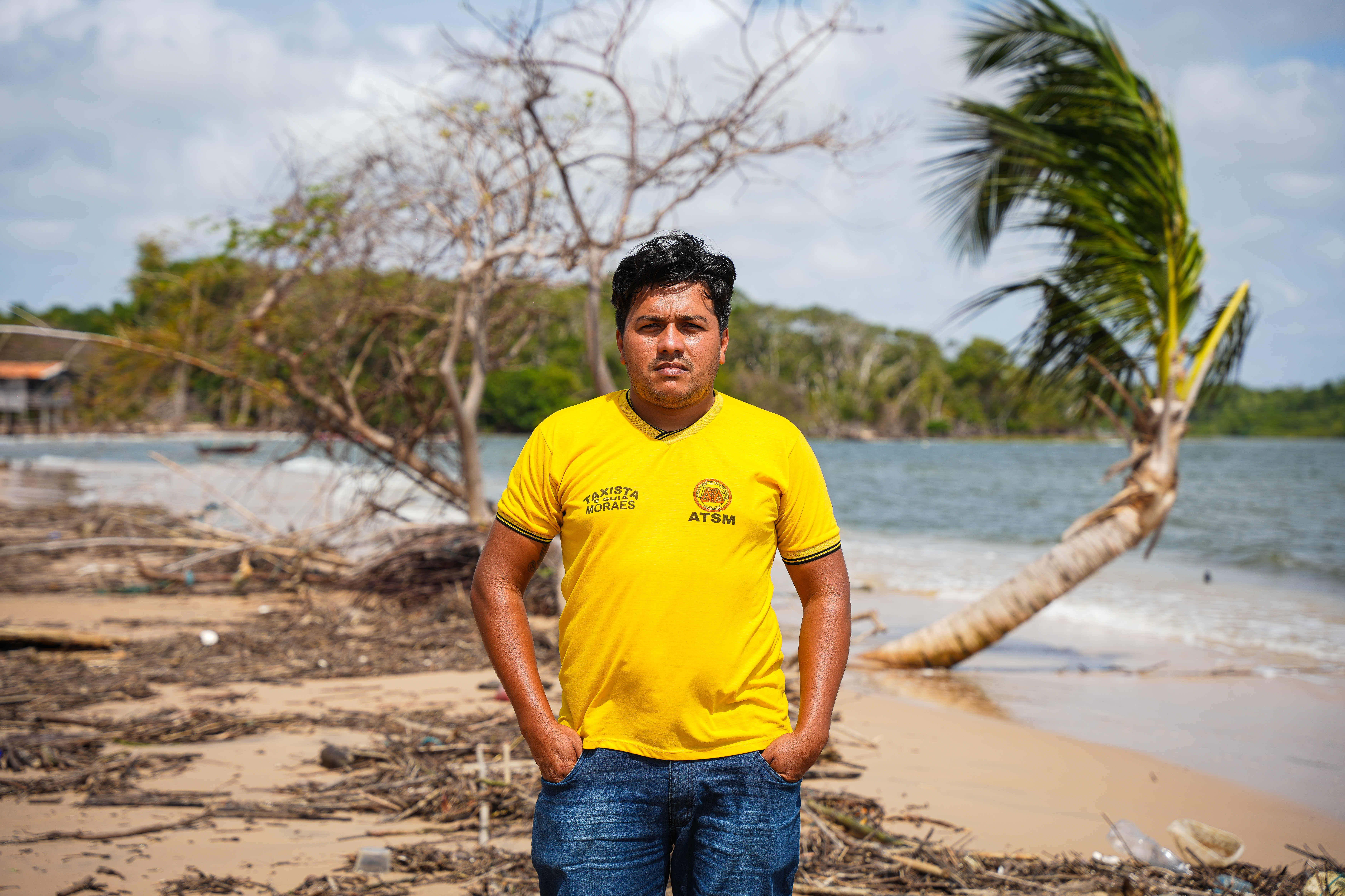 A man poses for a photo at a beach.