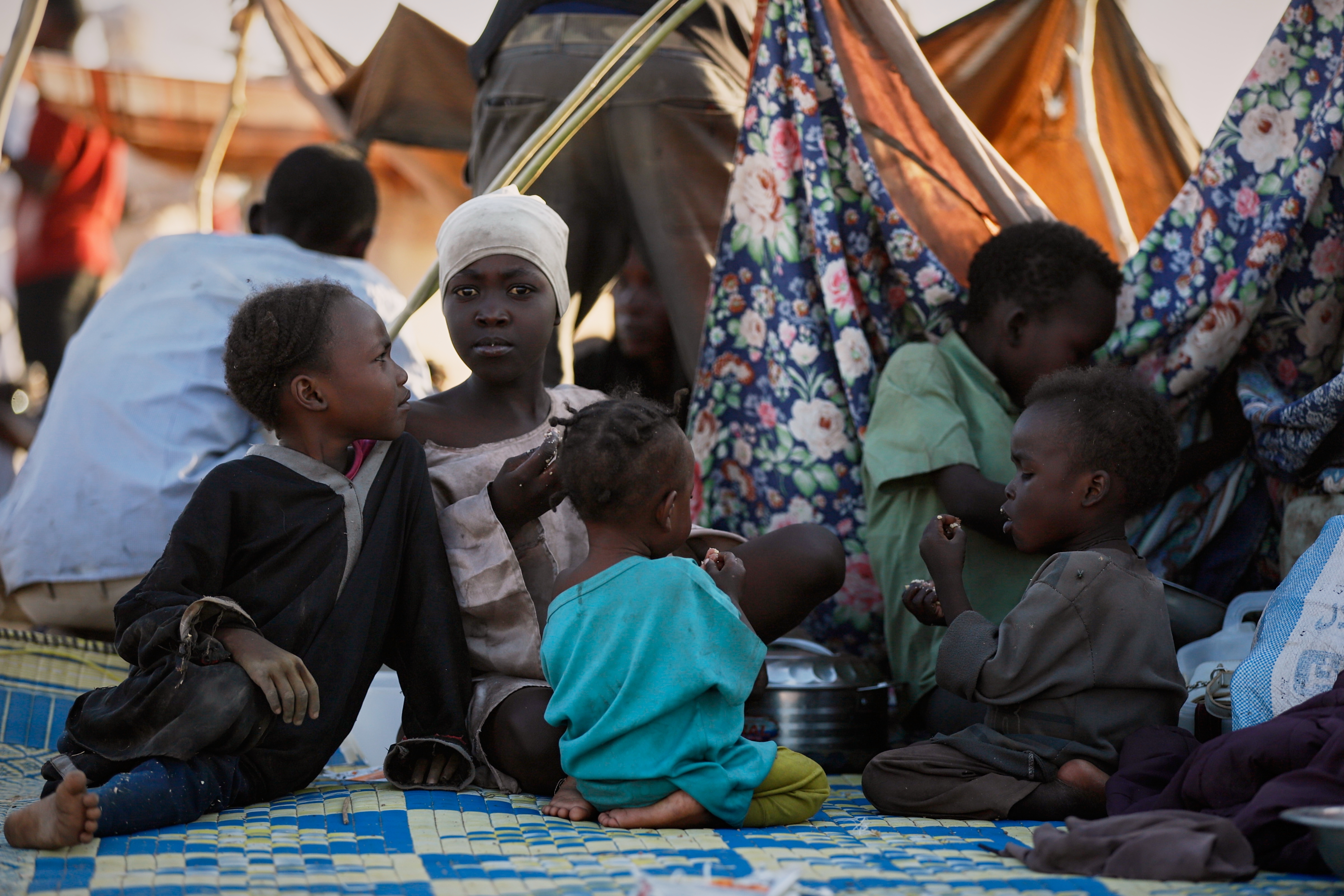 This photo released by UNICEF shows displaced children and families from el-Fasher at a displacement camp where they sought refuge from fighting between government forces and the RSF, in Tawila, Darfur region, Sudan, Monday, Oct. 27, 2025. (MohammedJammal/UNICEF via AP)