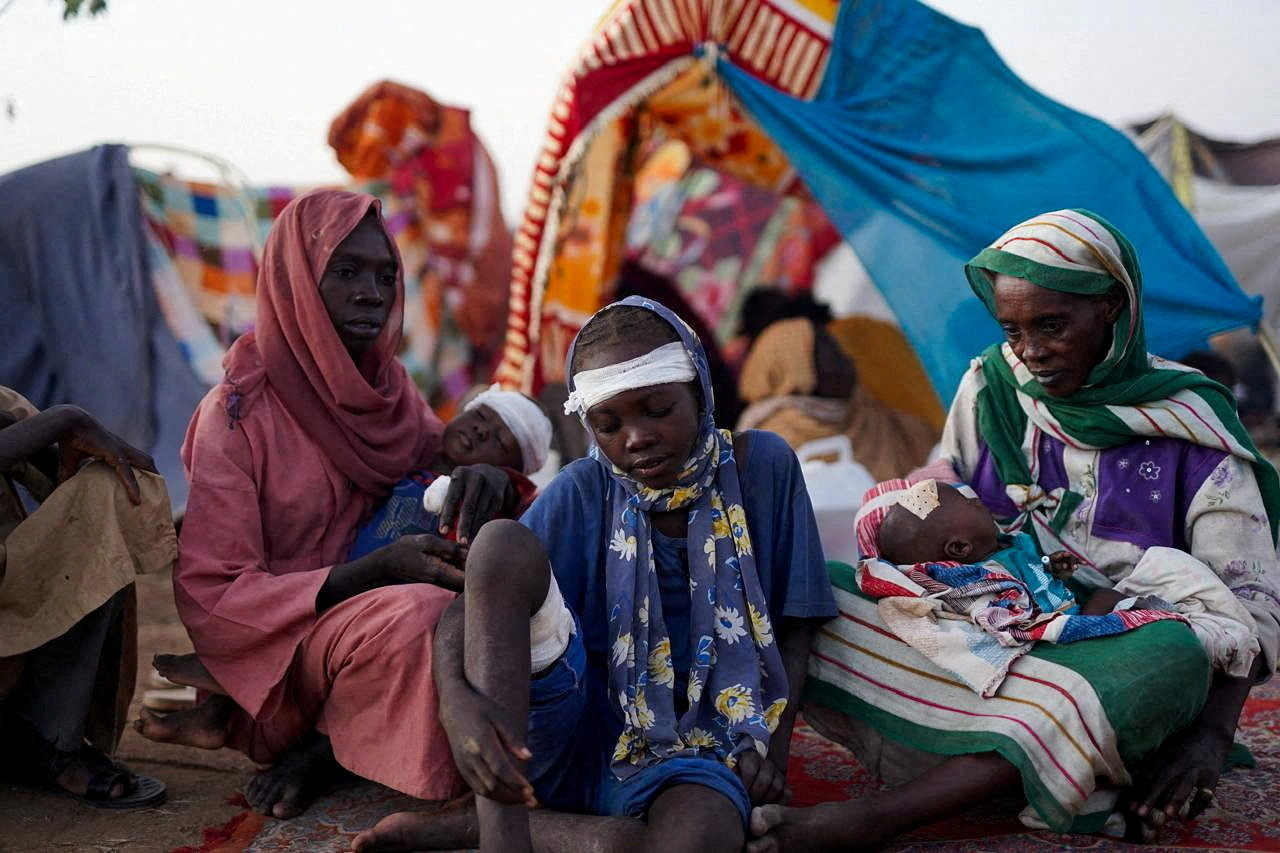 Ikram Abdelhameed looks on next to her family while sitting at a camp for displaced people who fled from al-Fashir to Tawila, North Darfur, Sudan, October 27, 2025. REUTERS/Mohammed Jamal REFILE - CORRECTING ID FROM "GRANDMOTHER OF IKRAM ABDELHAMEED" TO "IKRAM ABDELHAMEED".