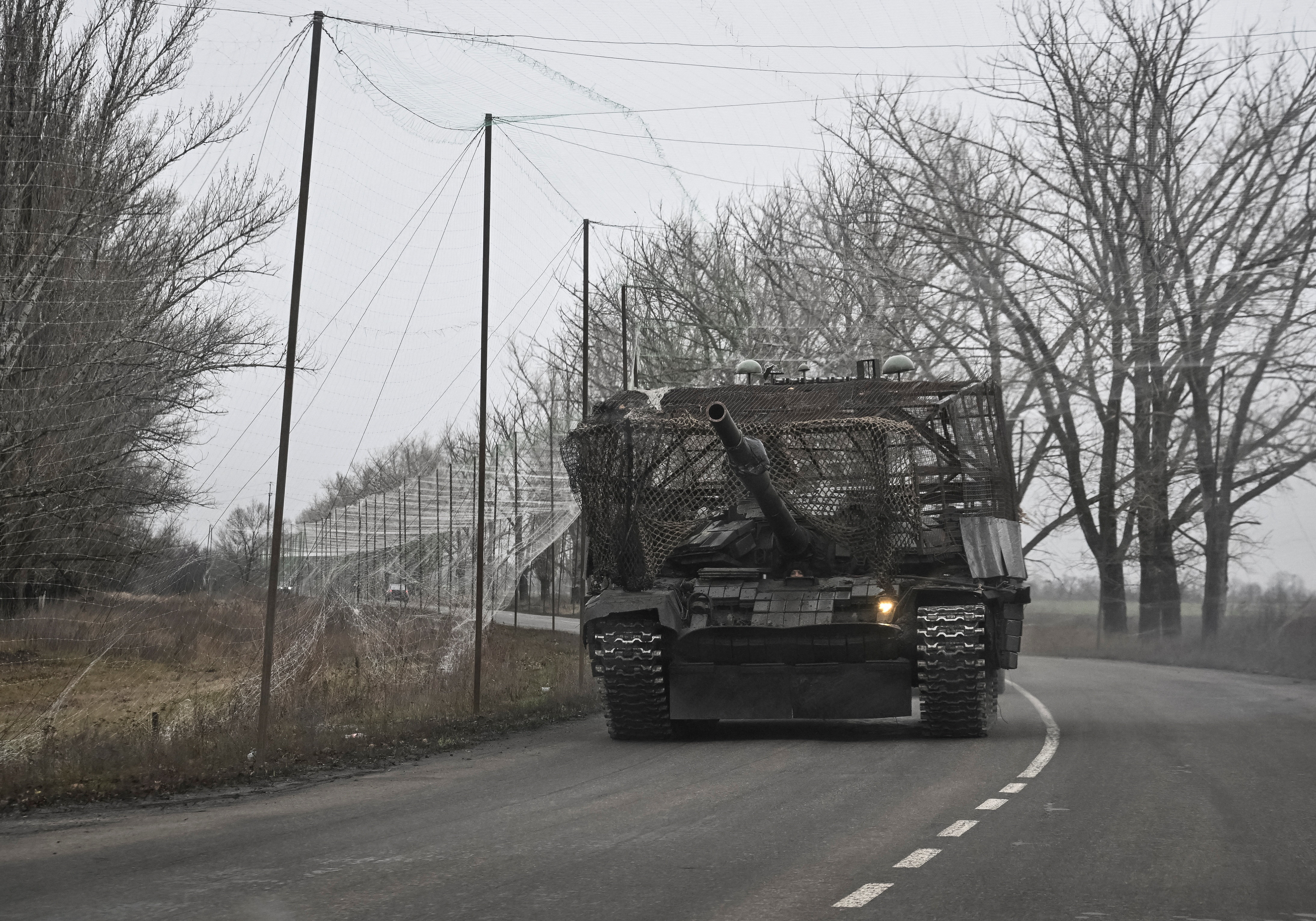 Ukrainian servicemen ride a tank installed with a grille and electronic warfare systems as combat drones protection near a front line, amid Russia's attack on Ukraine, near the town of Pokrovsk in Donetsk region, Ukraine November 20, 2025. REUTERS/Stringer