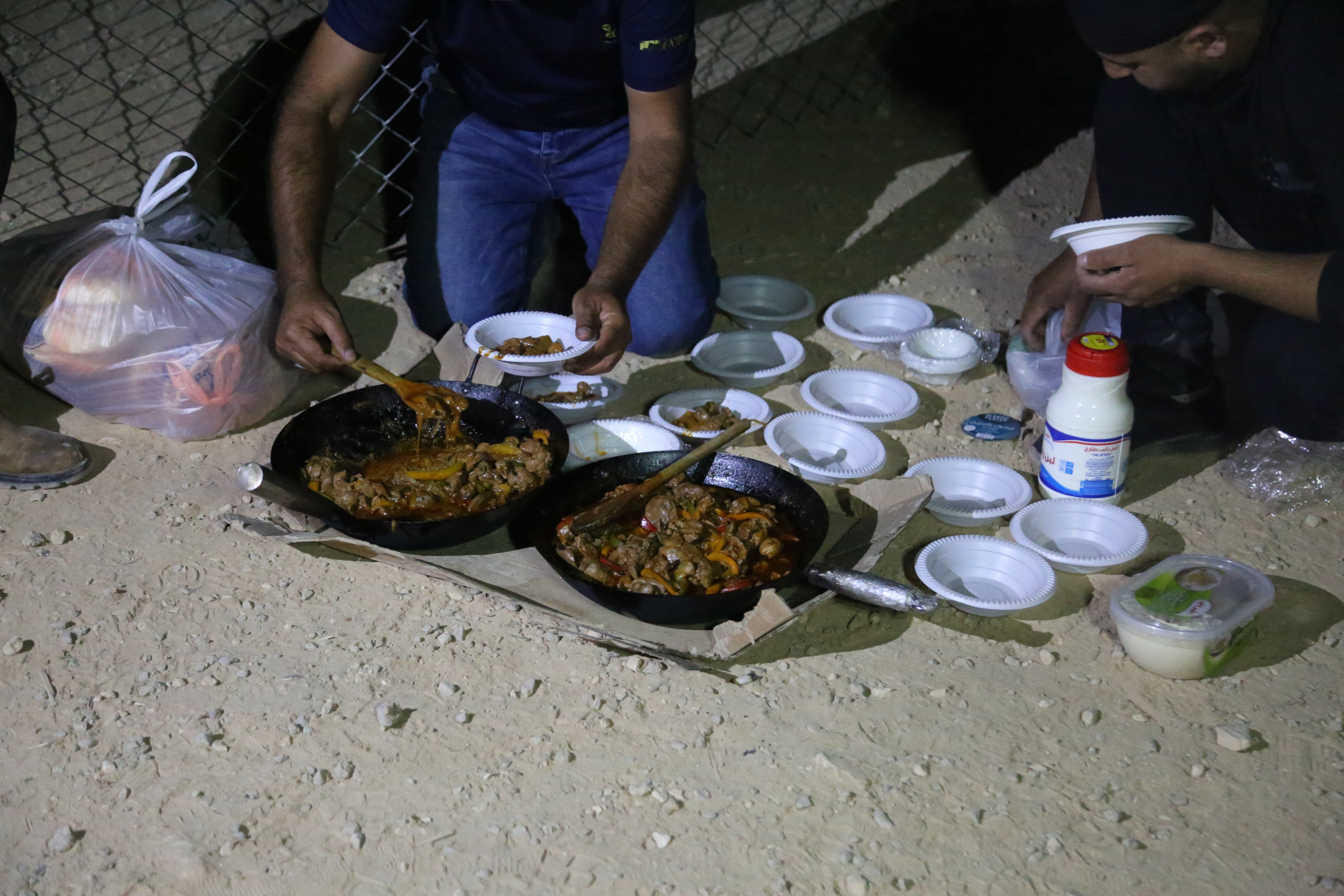 A photo of one of the guardians dishing out hot chicken livers (that look delicious) for the others