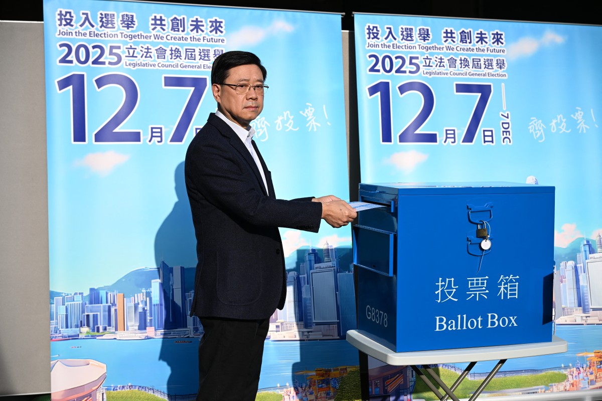 Hong Kong Chief Executive John Lee casts his vote in the Legislative Council elections in Hong Kong on December 7, 2025. (Photo by Peter PARKS / AFP)