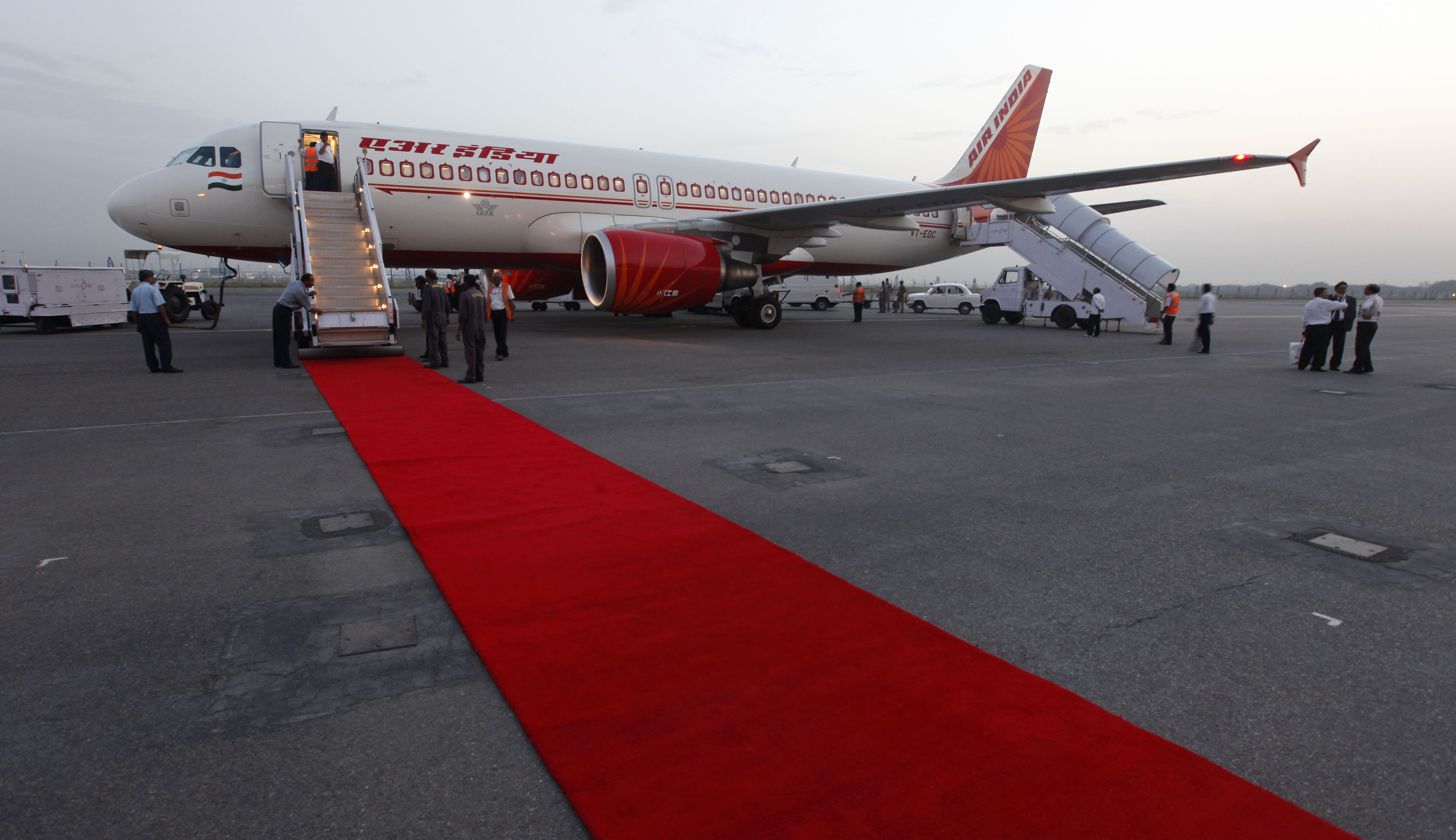 FILE-In this May 11, 2012, file photo, An Air India aircraft stands at the Indira Gandhi International airport in New Delhi, India. India said Monday it plans to sell its entire stake in the national carrier Air India to shore up falling revenues and privatize the airline, after an initial attempt last year failed to attract a single bidder. (AP Photo/ Mustafa Quraishi, file)