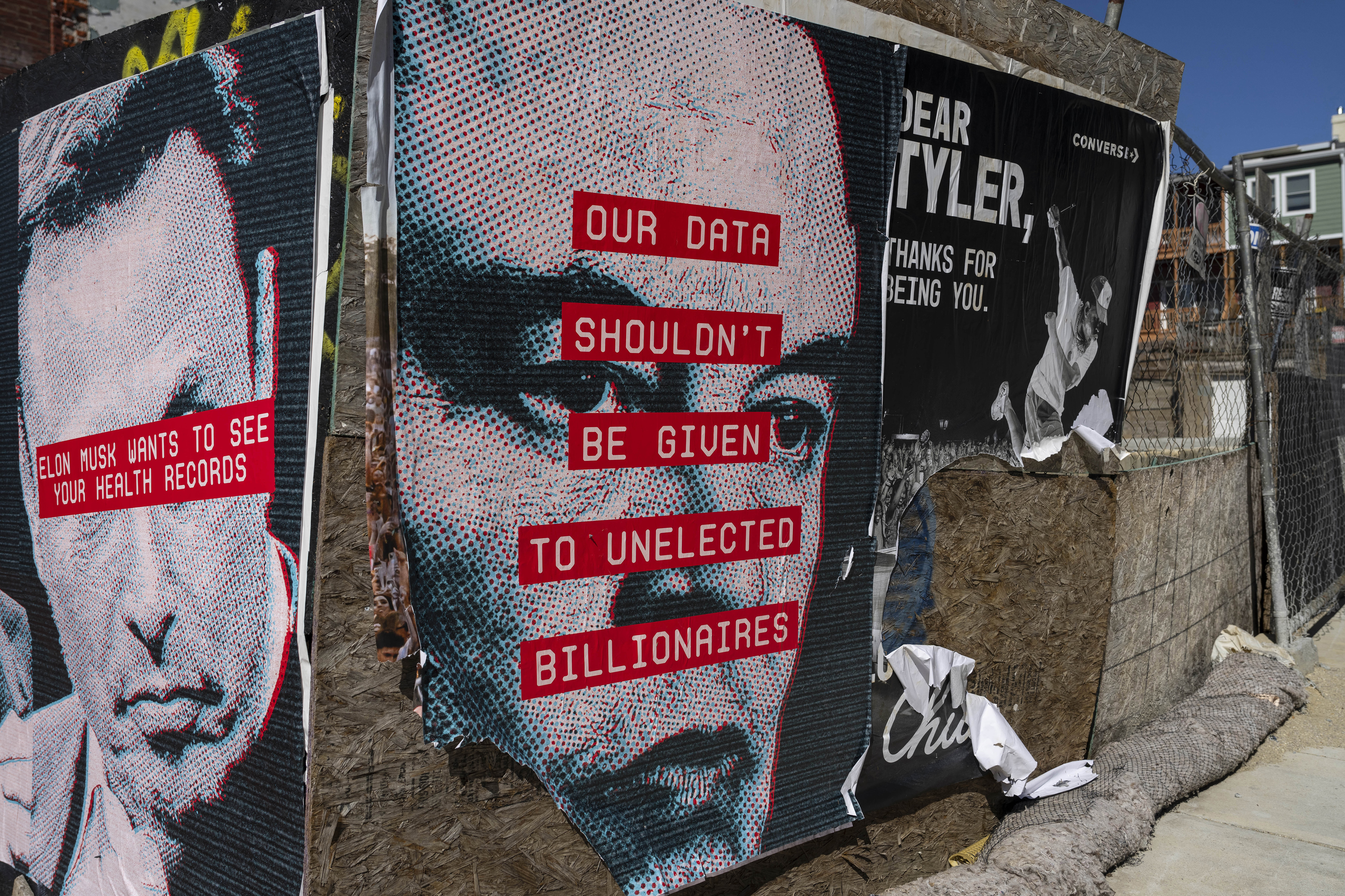 Poster graffiti featuring Elon Musk's face and the phrase, "Our data shouldn't be given to unelected billionaires"