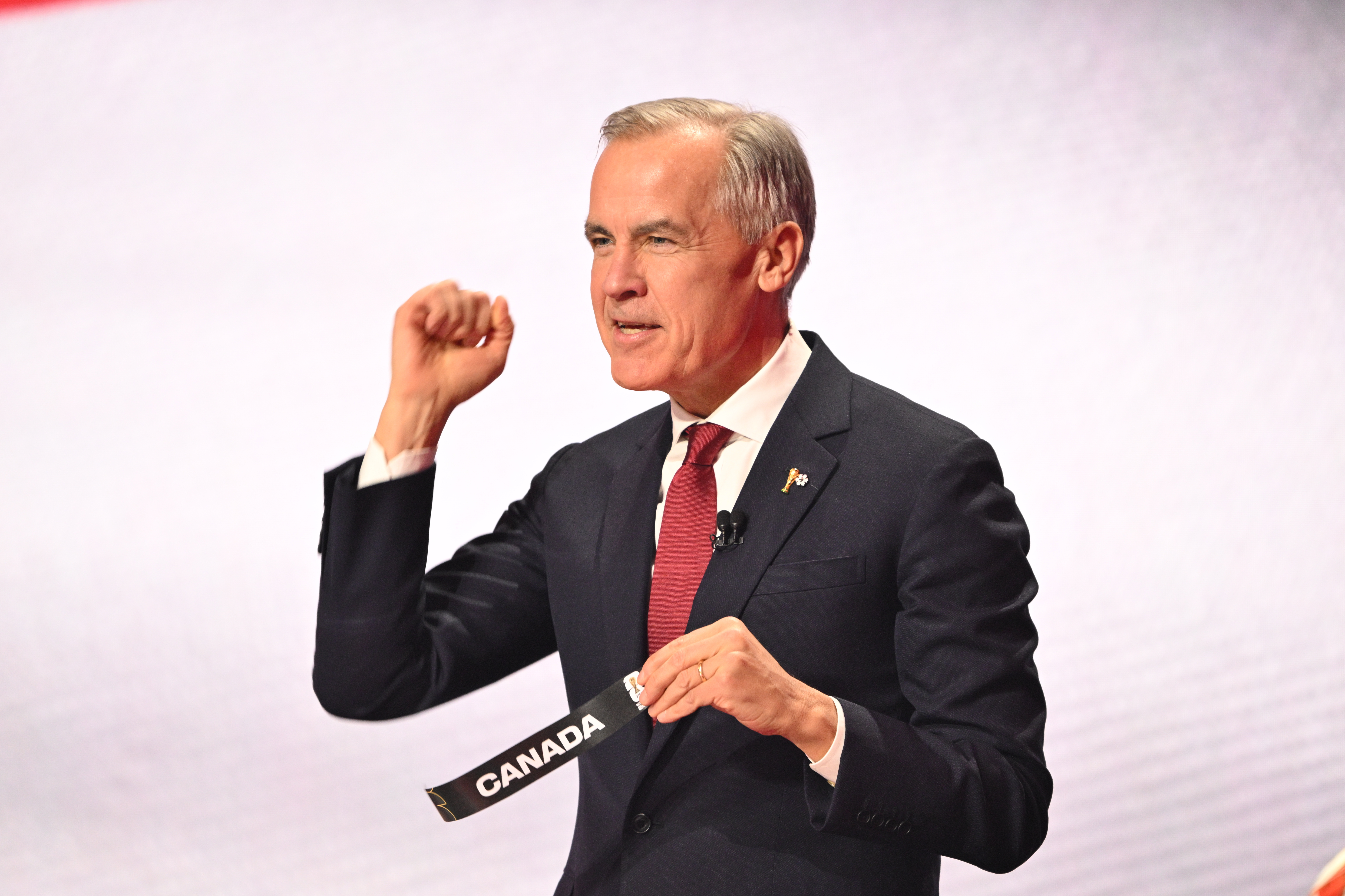 Canadian Prime Minister Mark Carney reacts after drawing Canada's name from a pot at the draw for the 2026 soccer World Cup at the Kennedy Center in Washington, Friday, Dec. 5, 2025. (Mandel Ngan/Pool Photo via AP)