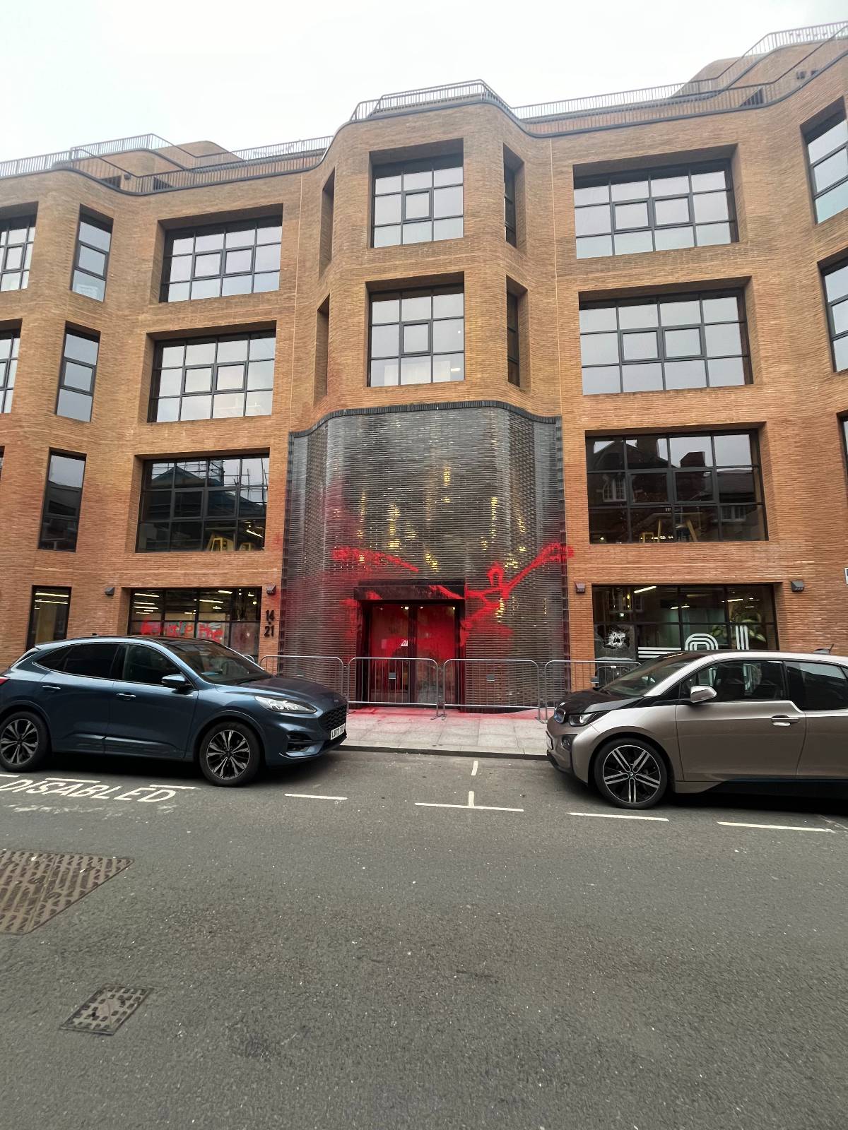 Pro-Palestine activists cover British Labour Party offices in red paint.