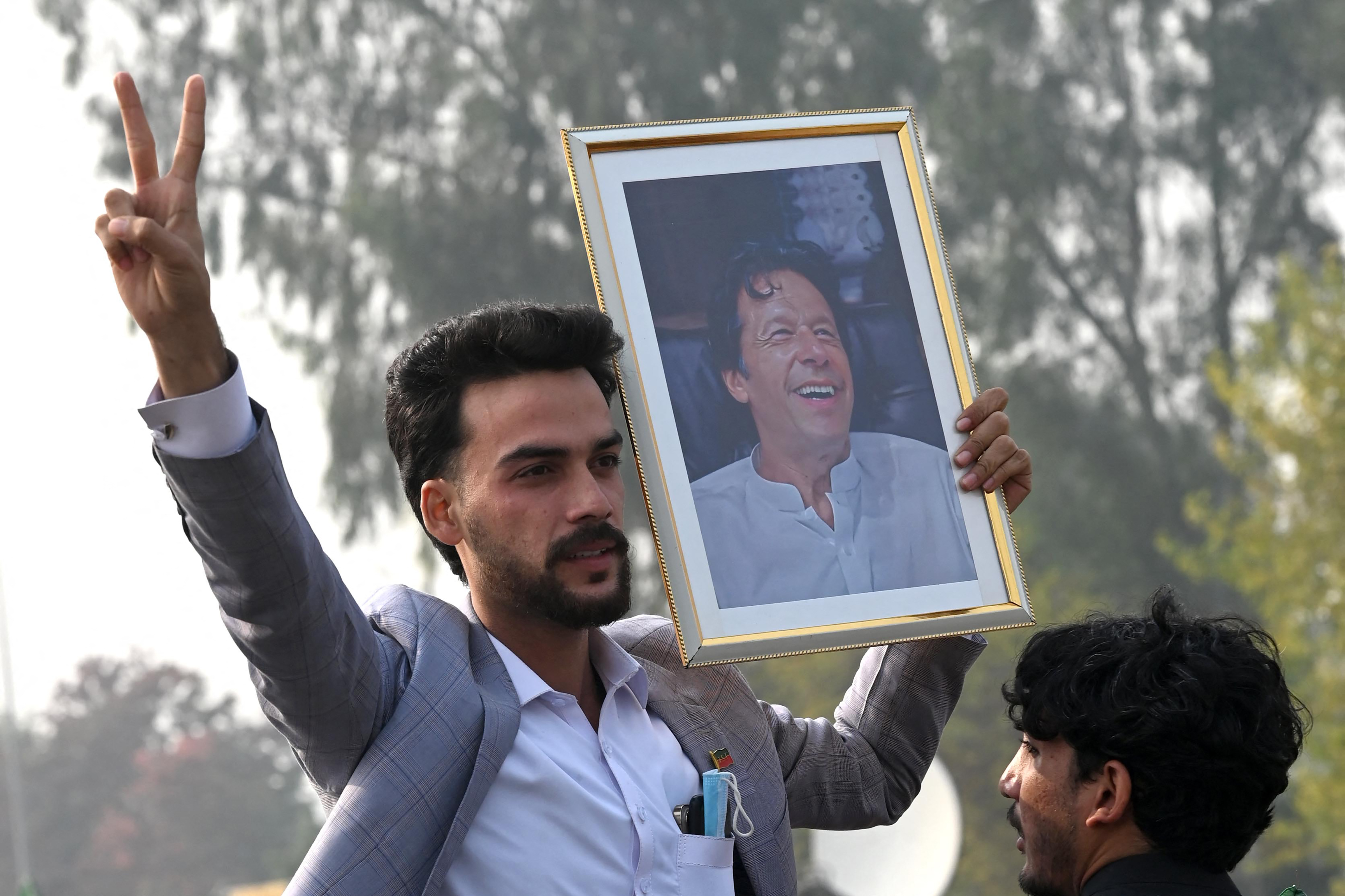 Pakistan Tehreek-e-Insaf (PTI) party supporters protest to demand release of their jailed leader and Pakistan's former Prime Minister Imran Khan, in Peshawar on December 2, 2025.