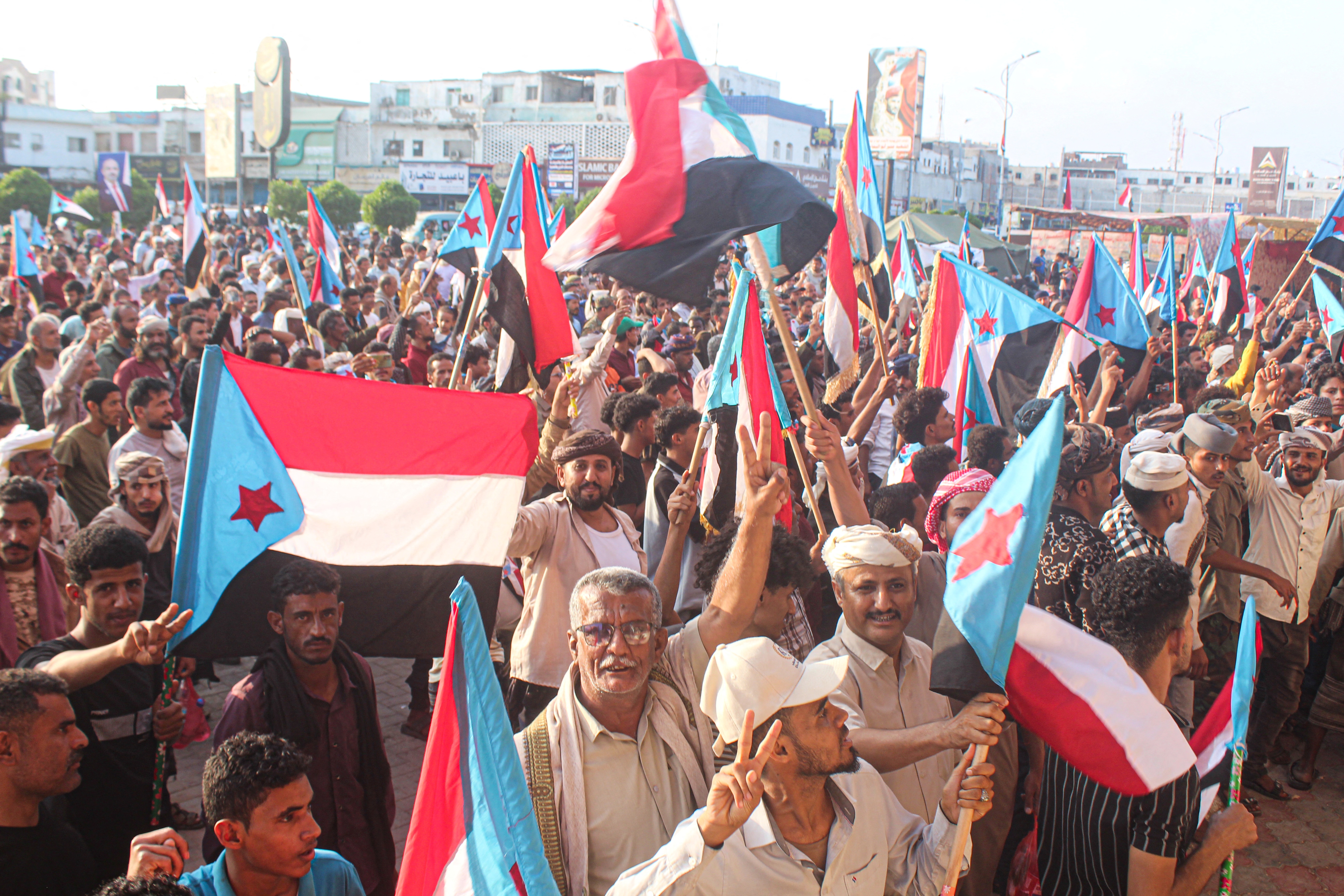 People carry flags as they take part in a protest.