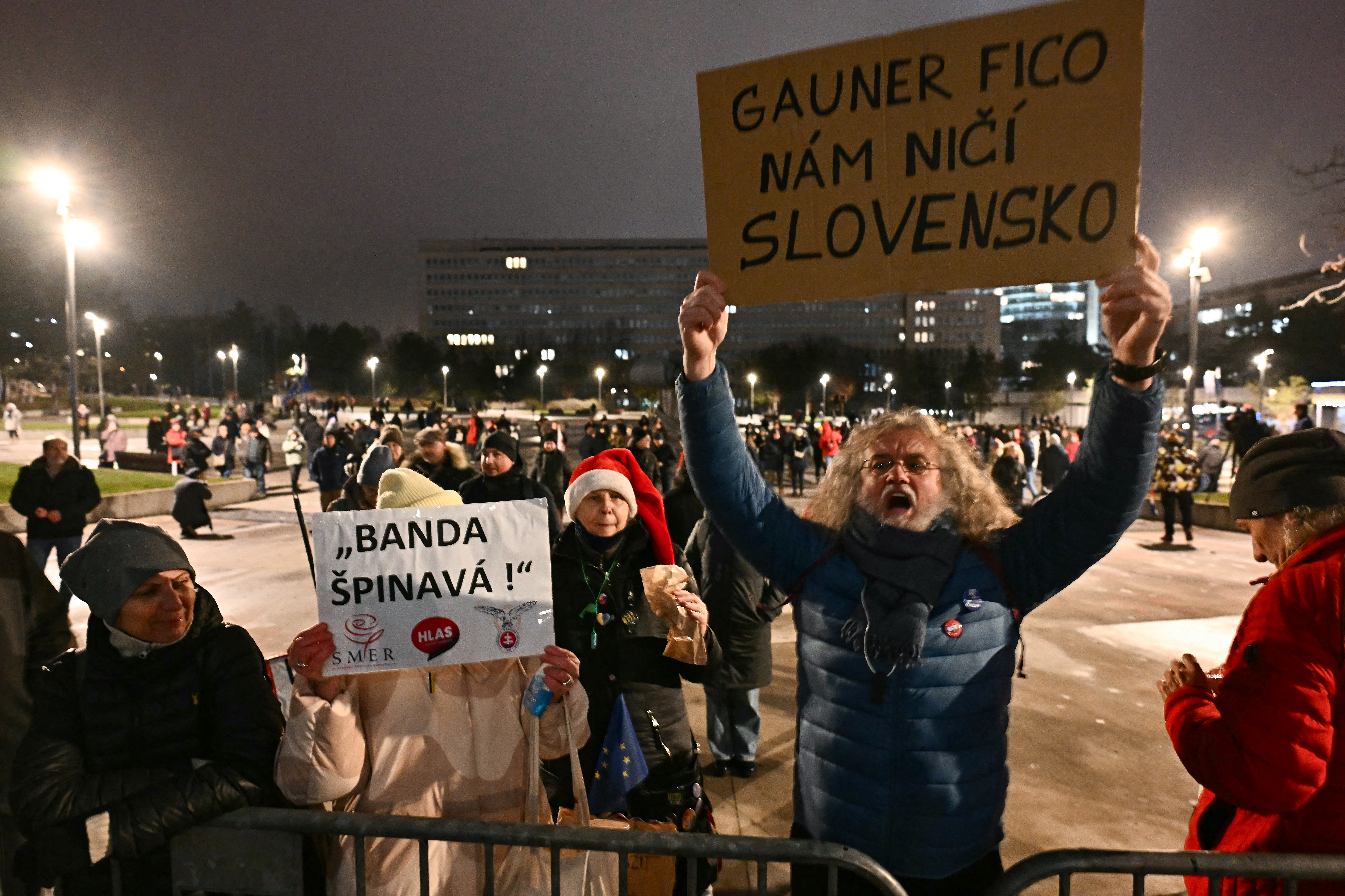 A demonstrator holds up a placard with the lettering reading "Gangster Fico destroys our Slovakia" during a protest against the abolition of the whistleblower protection office and penal code changes in Bratislava, Slovakia on December 15, 2025.