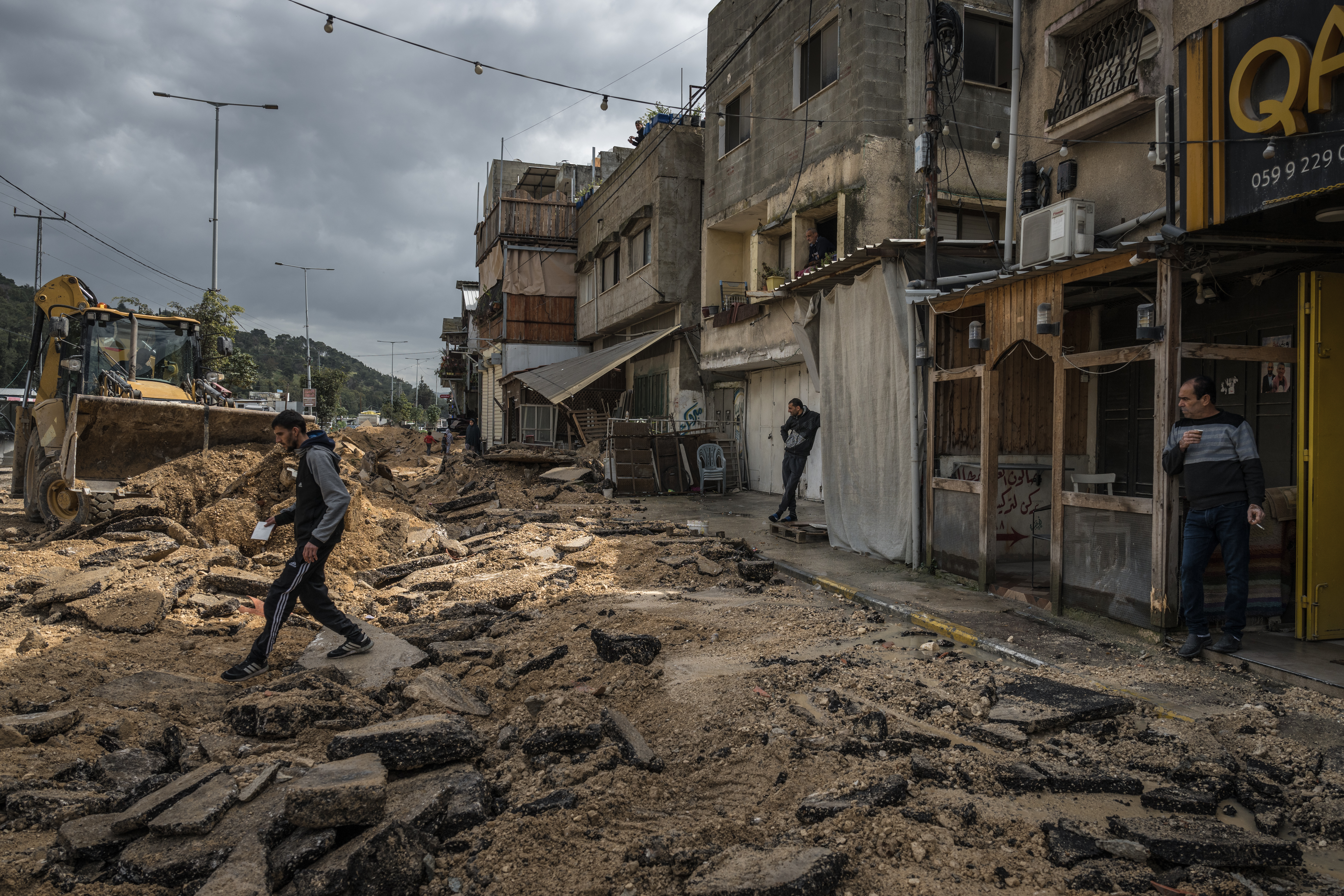NUR SHAMS, WEST BANK - MARCH 4: Palestinians survey a destroyed pavement following an Israeli raid in the Nur Shams camp near Tulkarem on March 4, 2024, West Bank. Israel's war against Hamas in Gaza has also reverberated through the West Bank, hobbling the territory's economy while unsettling its security. Since Oct. 7, Israeli forces have stepped up raids on alleged militants, police have clashed with protesters, and there has been a rise in violent attacks on Palestinians by Israeli settlers. (Photo by Sergey Ponomarev/Getty Images)
