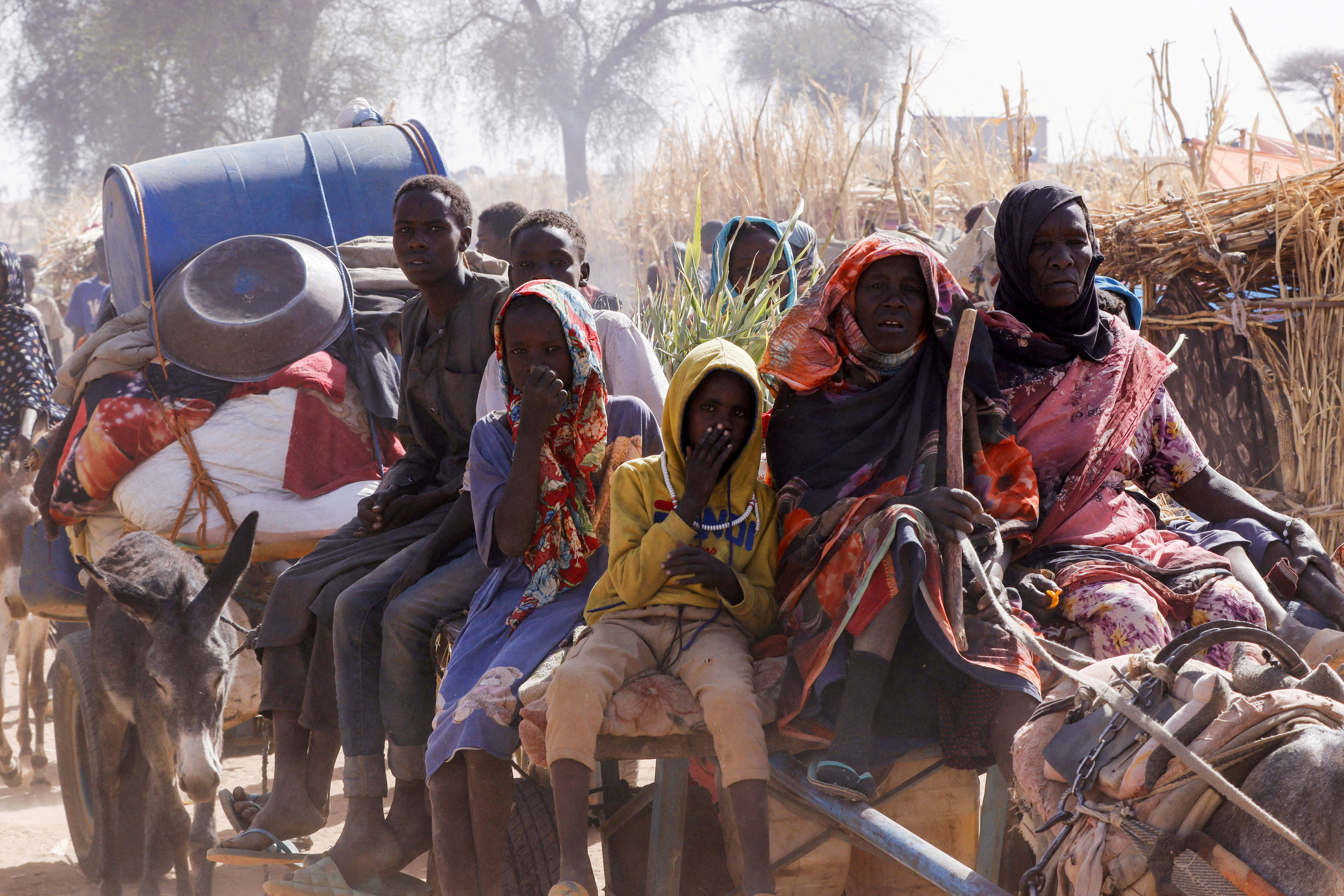 Displaced people ride an animal-drawn cart, following Rapid Support Forces' attacks on the Zamzam displacement camp, in Tawila, North Darfur, Sudan